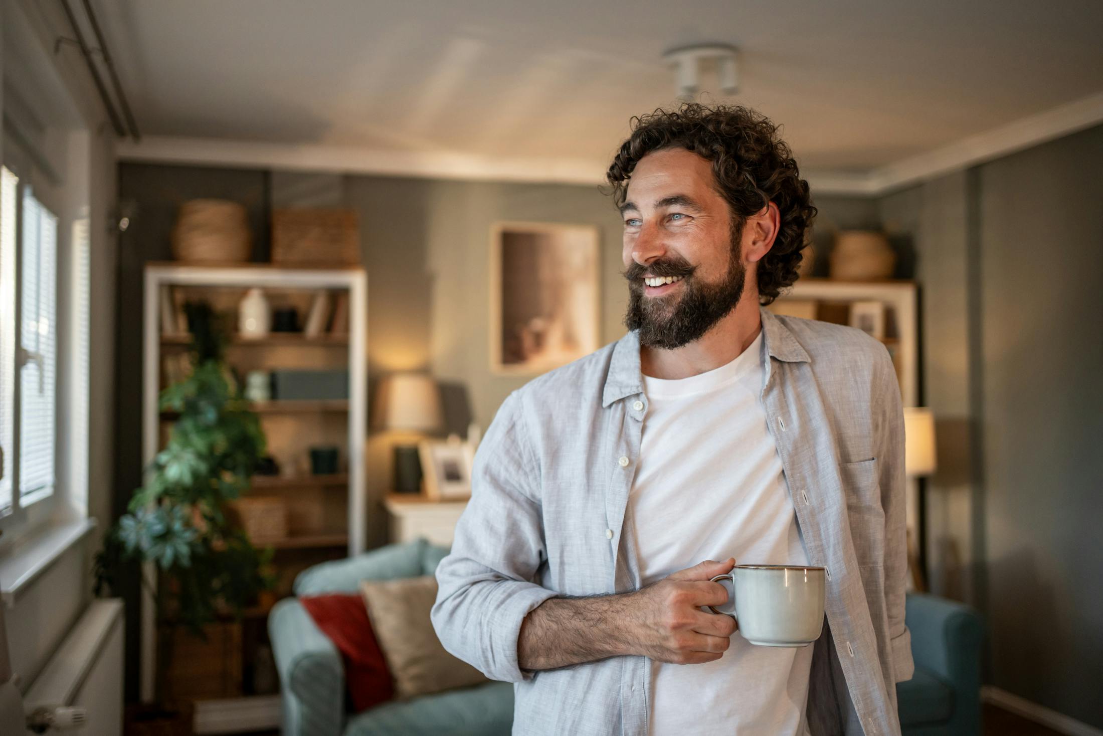 Man smiling holding mug