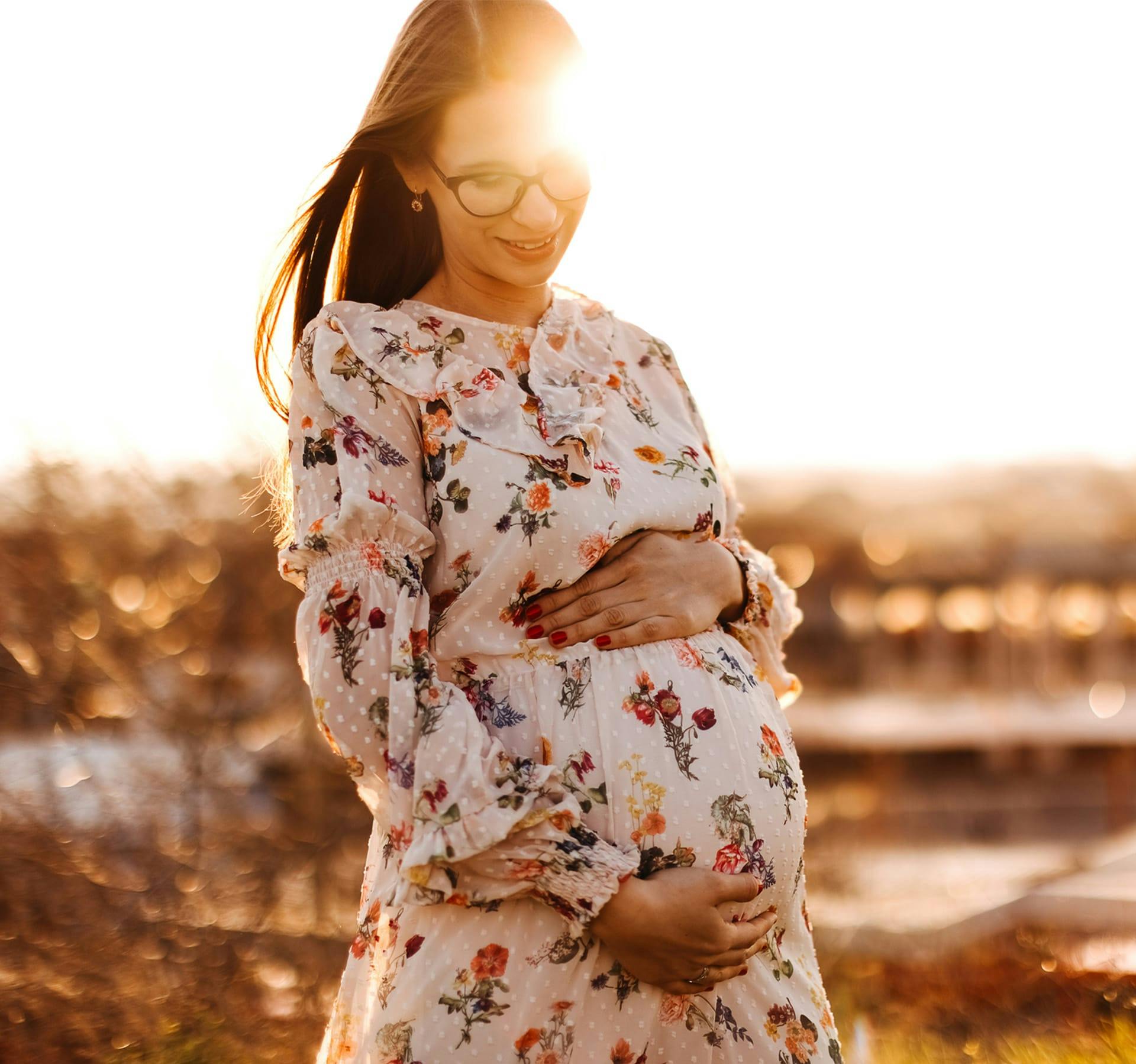 pregnant woman holding her belly