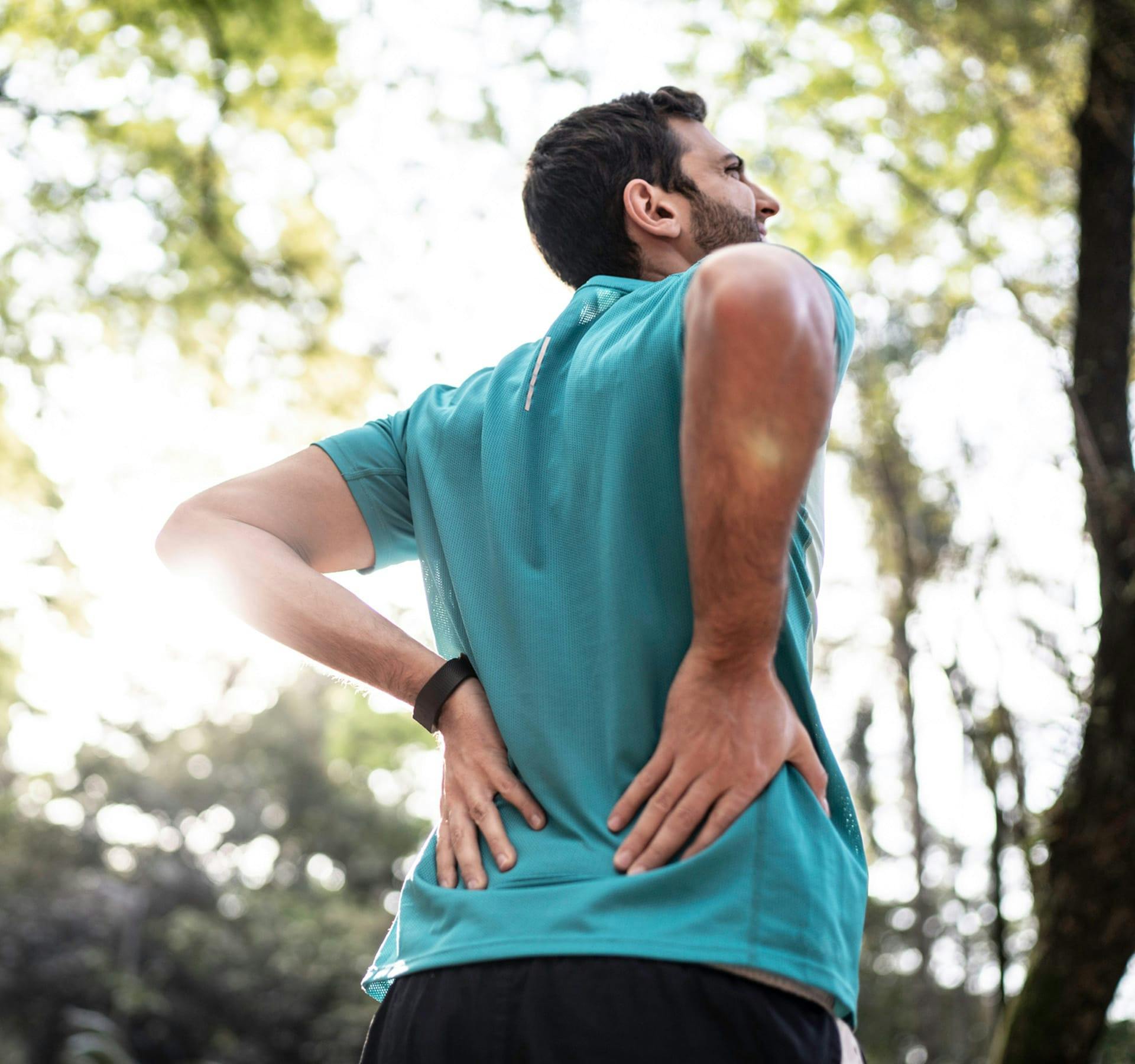 person holding their lower back