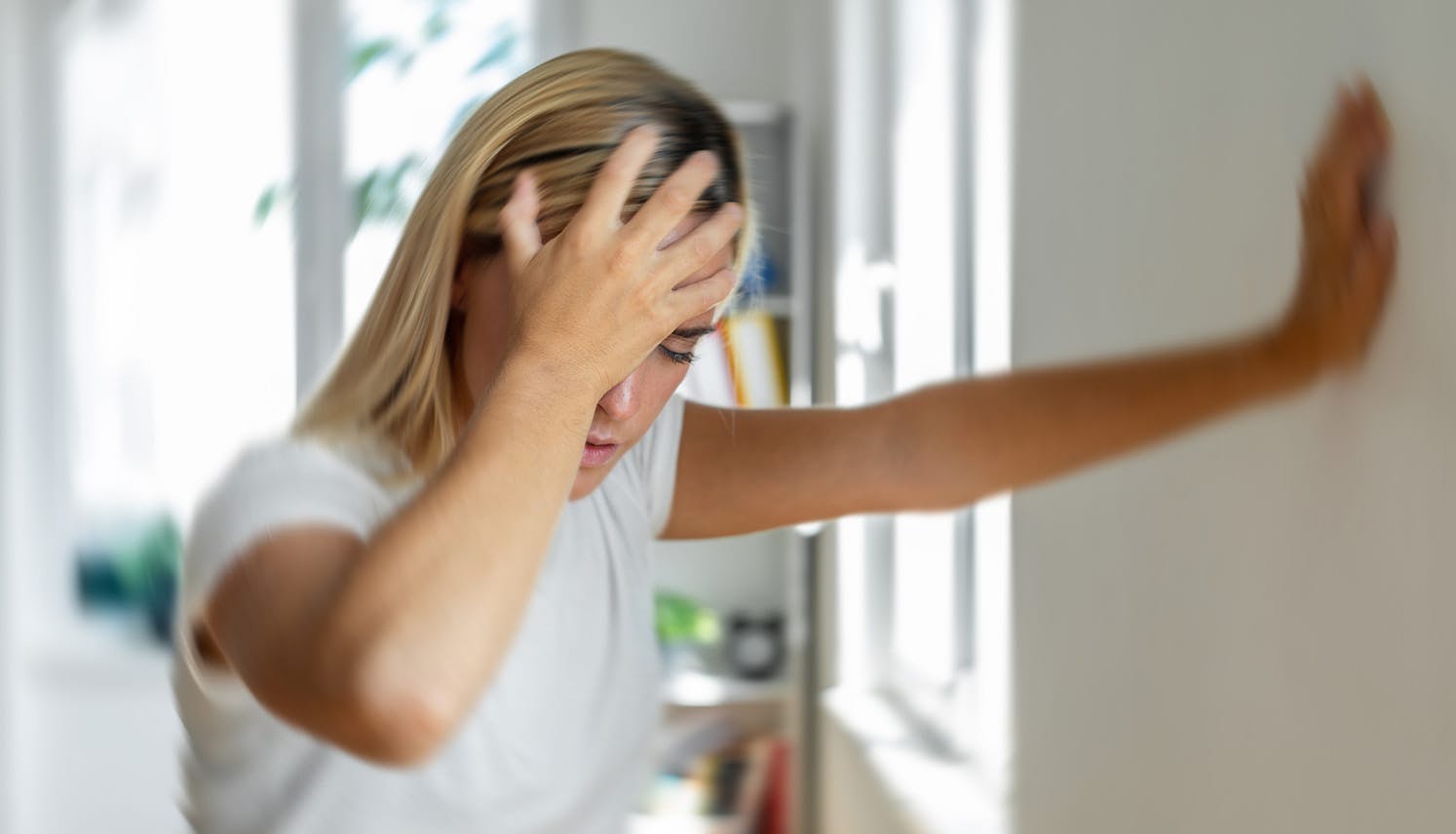 woman who is dizzy, holding her head