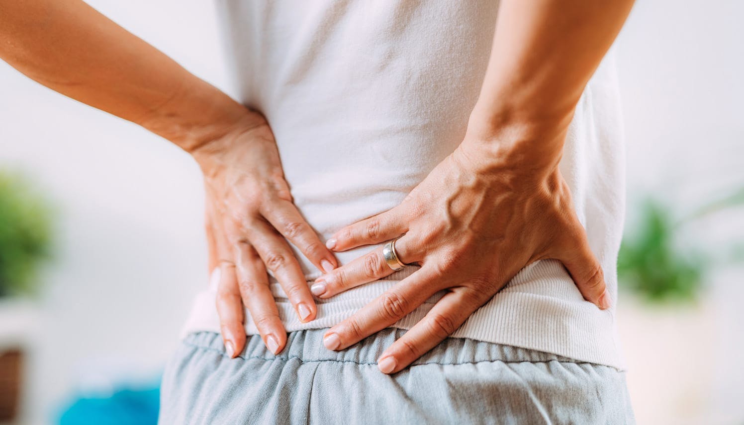 man holding his lower back