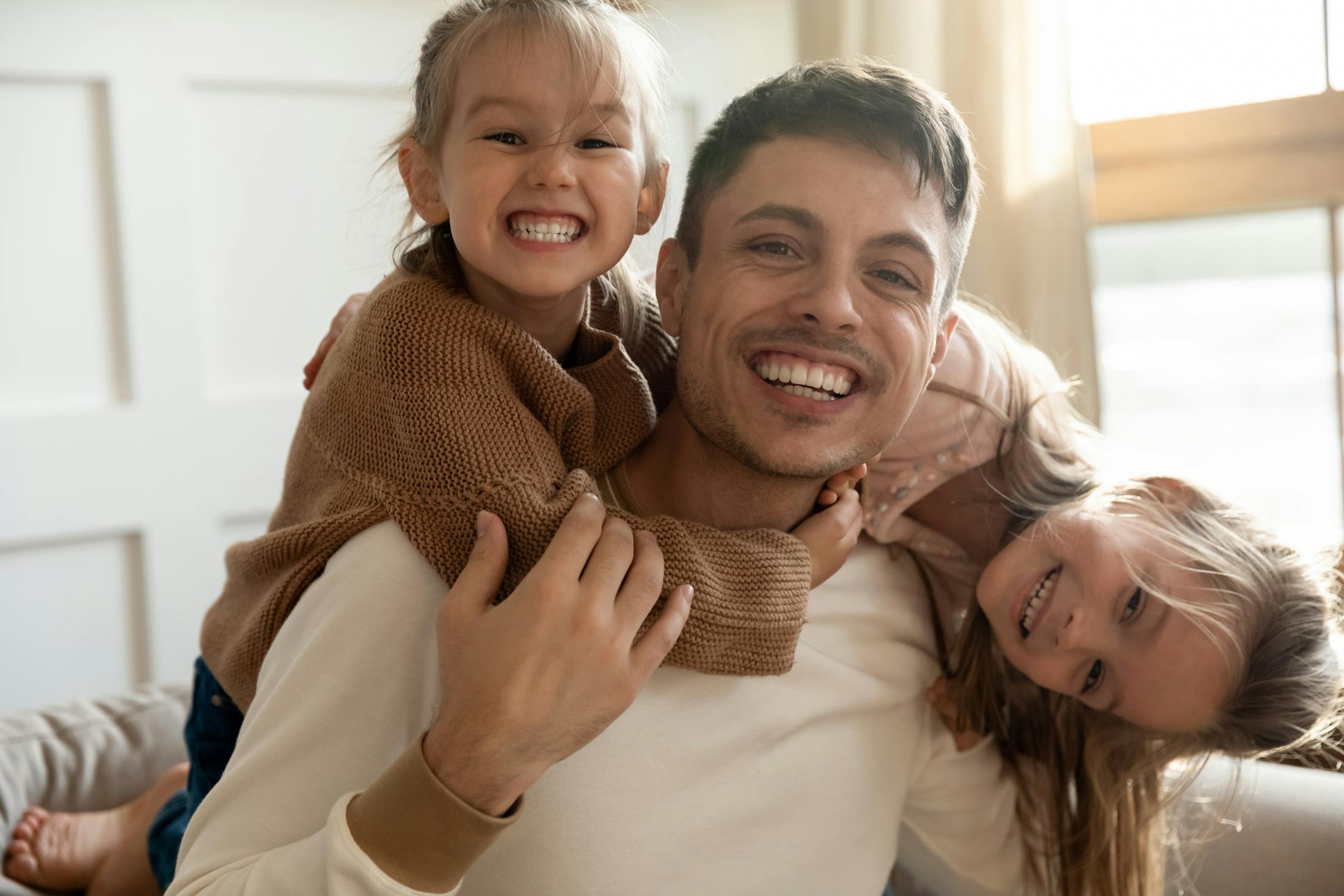 Dad playing with this two daughters