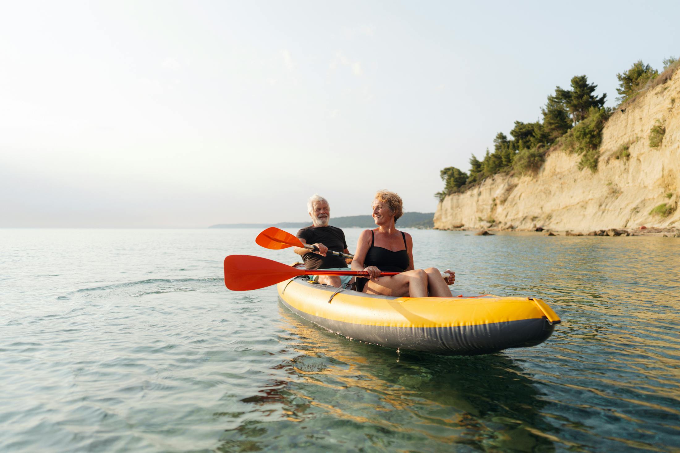 older couple canuing in a calm river