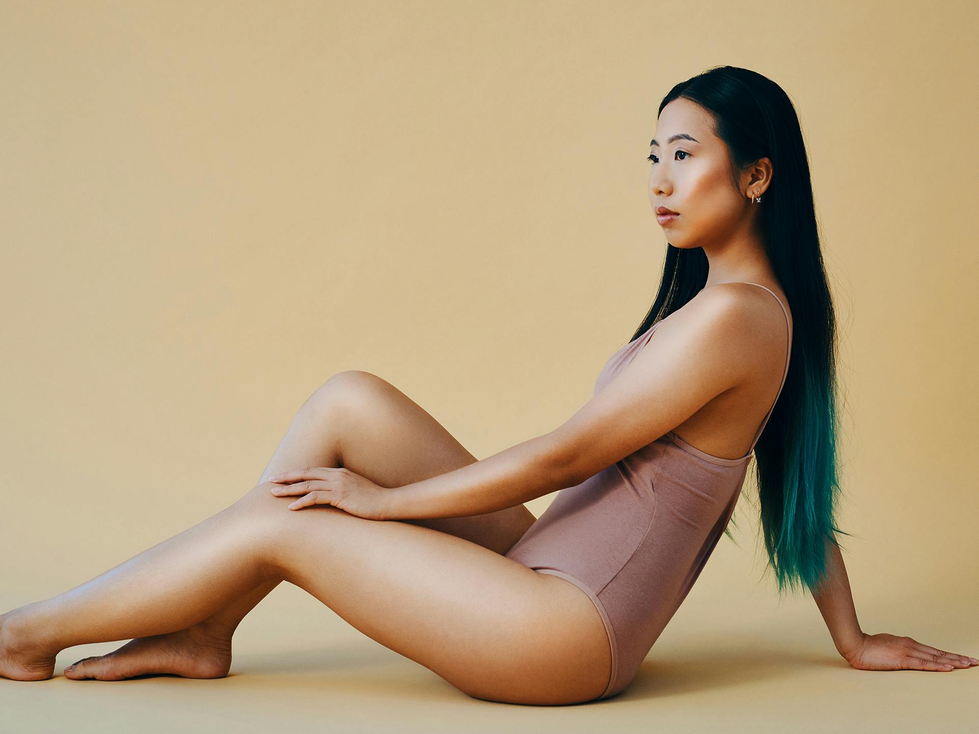 lady posing on floor with swimsuit