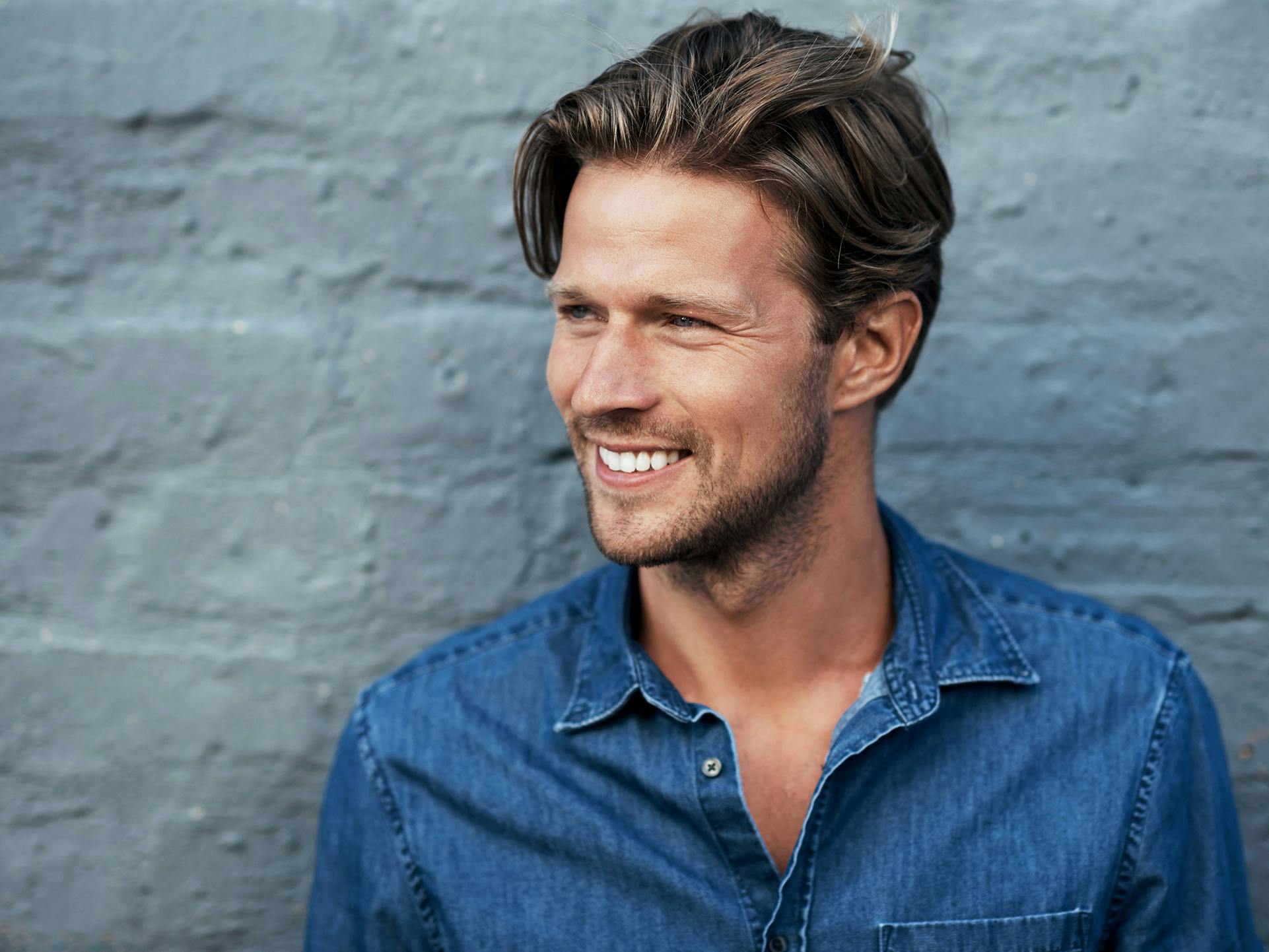 man smiling and wearing blue