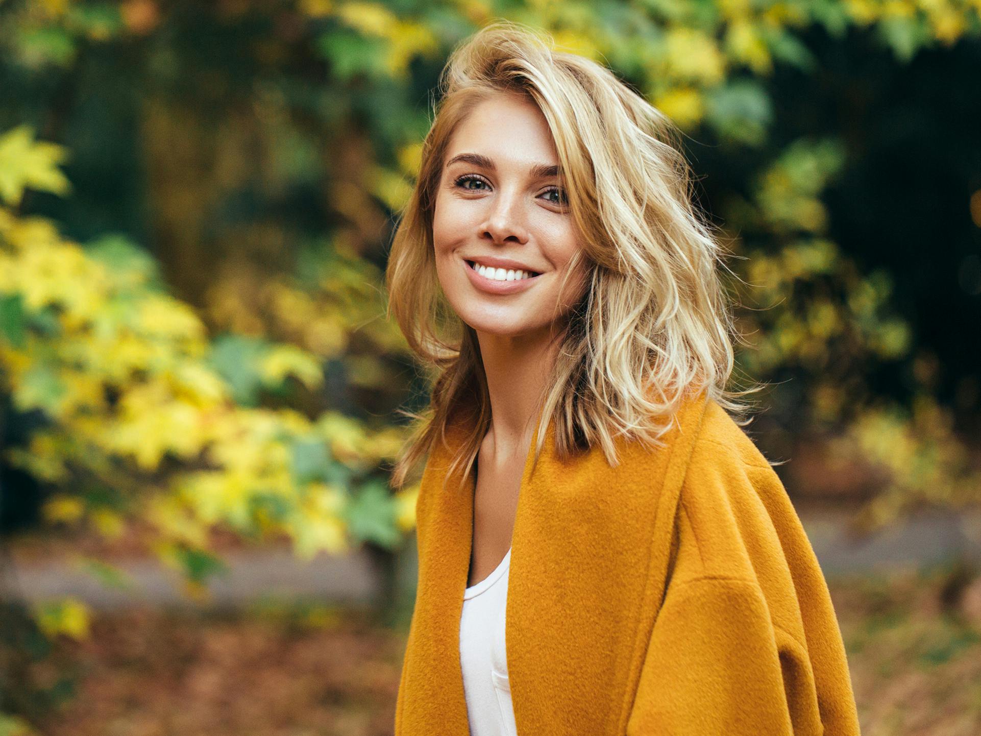 lady in yellow jacket smiling at camera