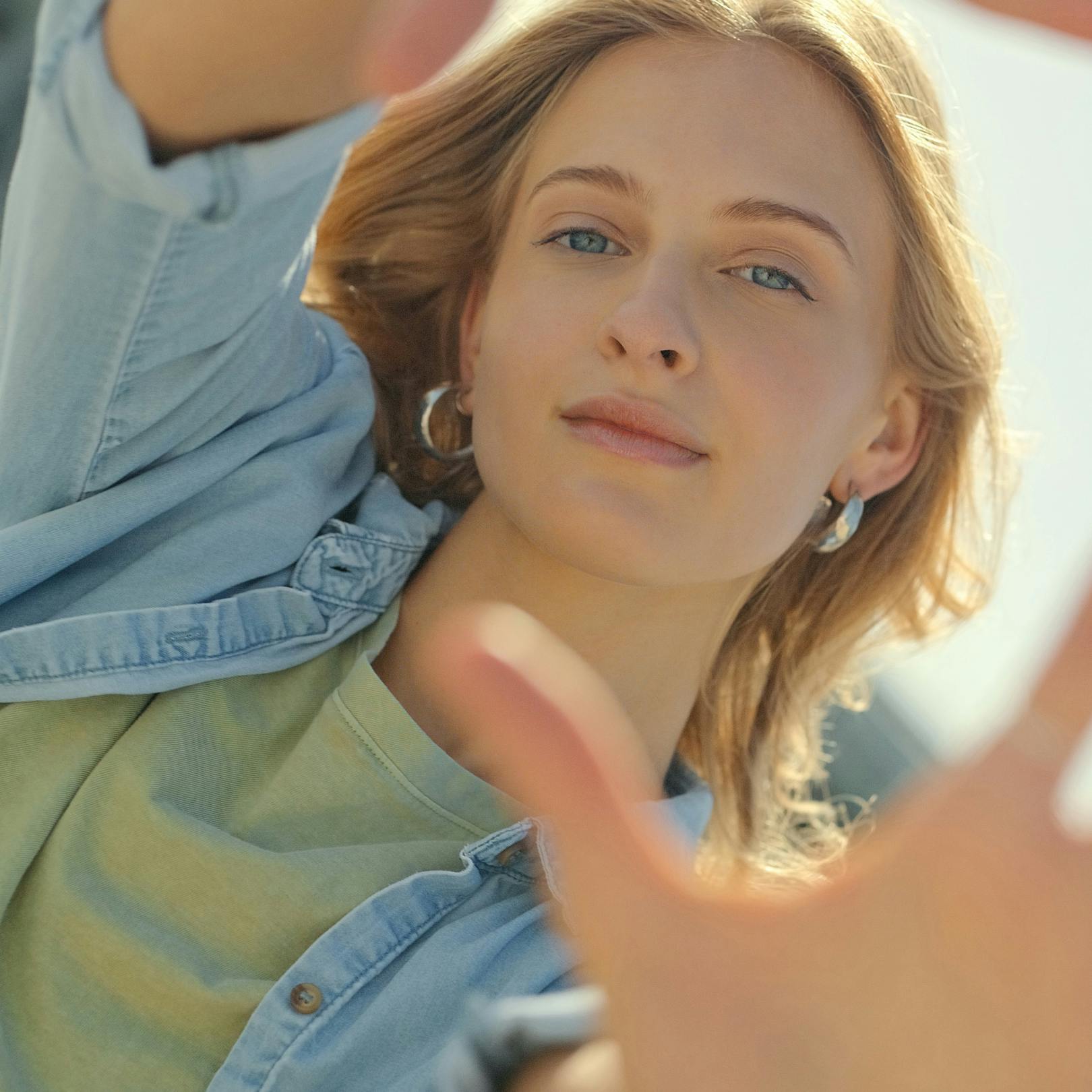 lady holding hands out at camera