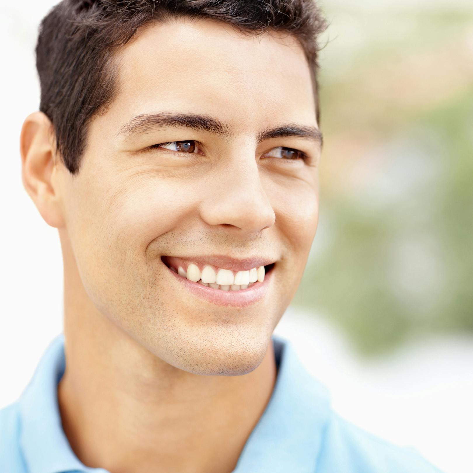 man in blue collored shirt smiling close up