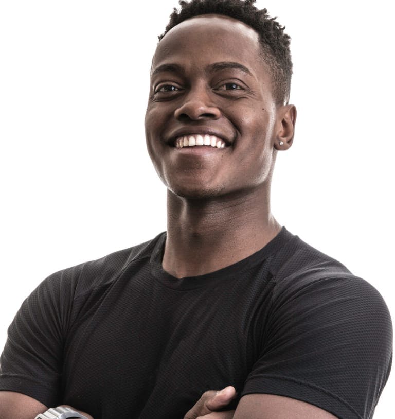 Man standing with arms folded and smiling