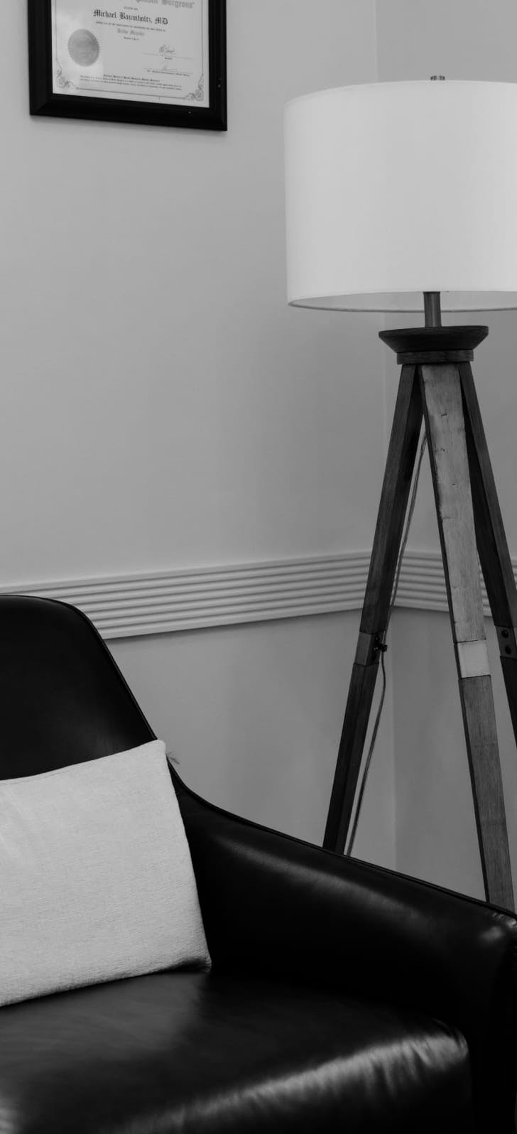 Image from Dr. Baumholtz's office showing a black leather chair and lamp