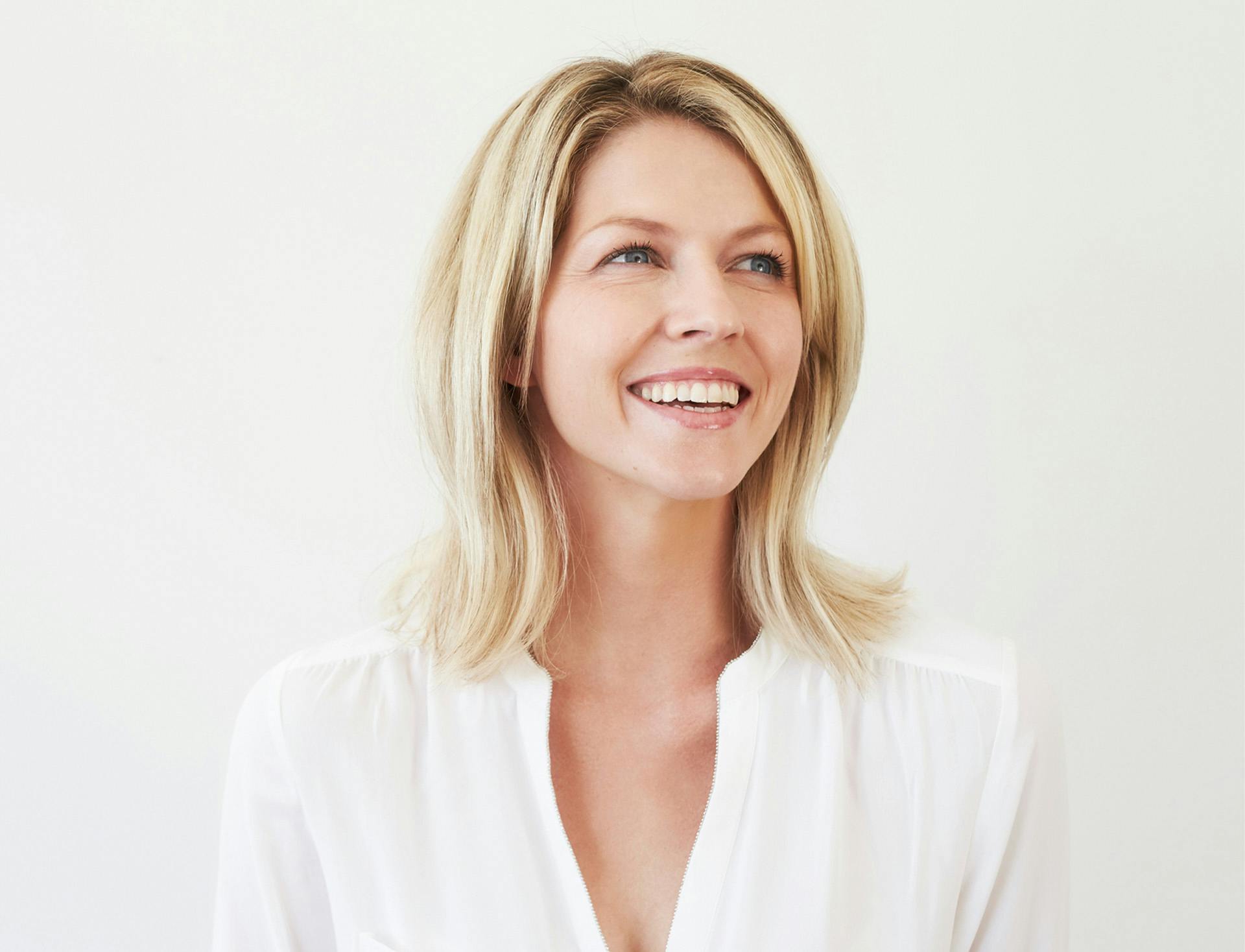 smiling in front of white background