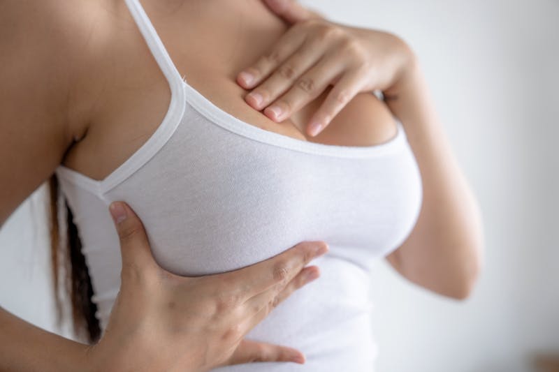 Woman holding breast.