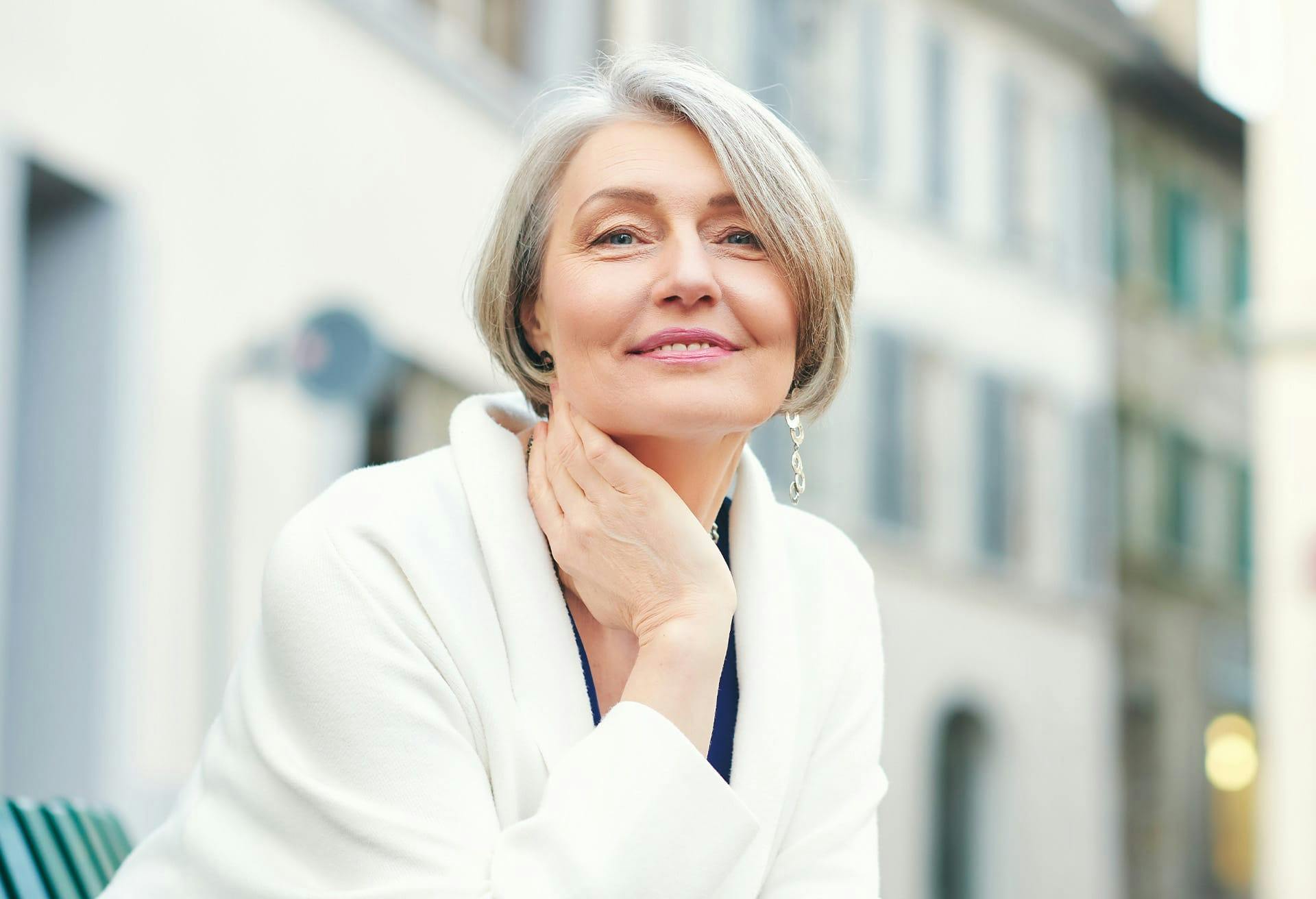 Woman with her hand on her neck