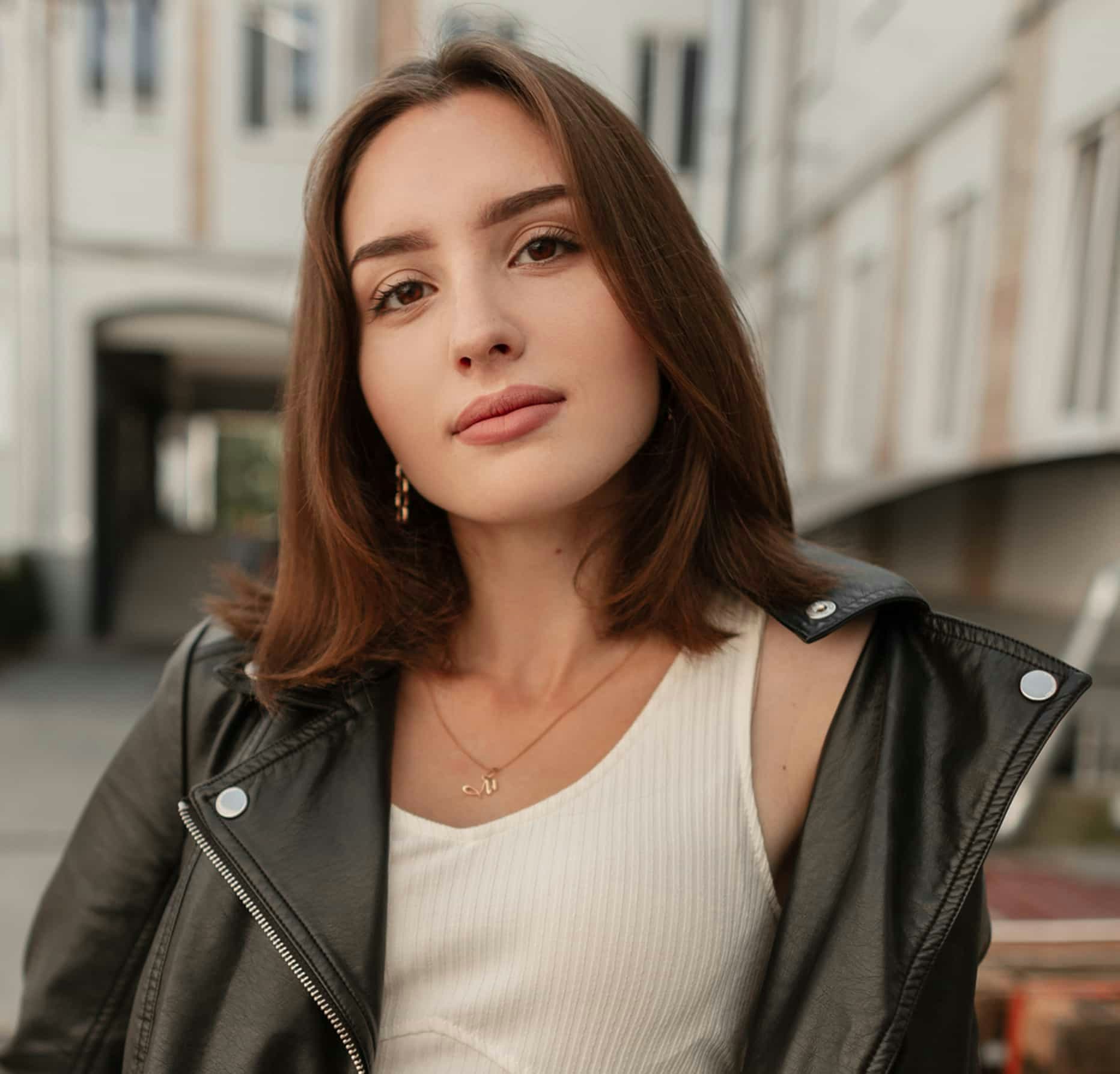 woman in a white top and black jacket