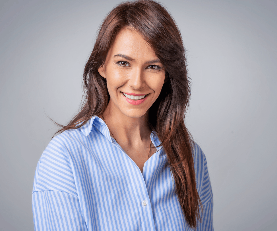 Older woman smiles at the camera in a studio shoot showing off the potential results of a Deep Plane Facelift in Beverly Hills