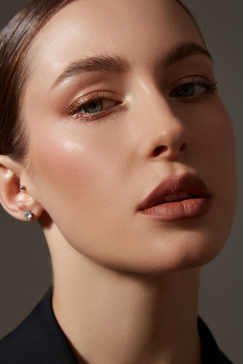 Gorgeous woman poses in a stylized studio shoot. She has a beautiful nose to show the potential results of a rhinoplasty in Beverly Hills with Dr. Torkian