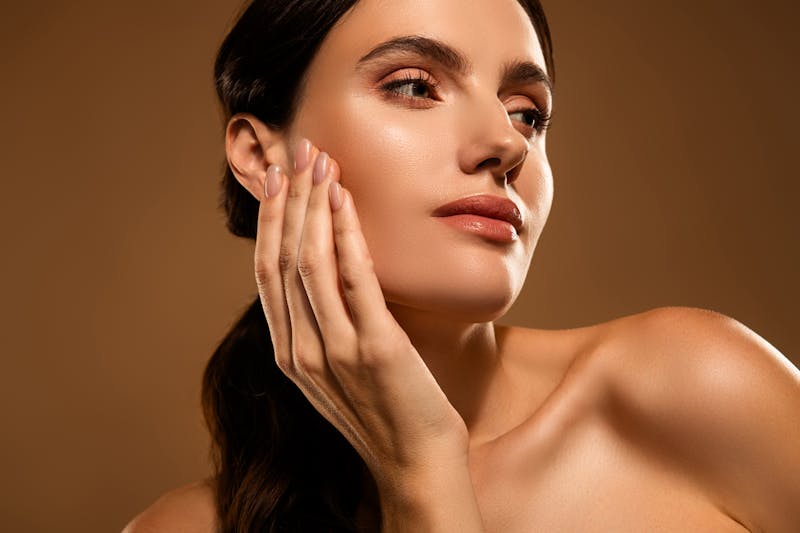 Portrait of a beautiful young woman with flawless skin in a serene and luxurious setting, emphasizing elegance and personal care a beautiful profile with a revision rhinoplasty