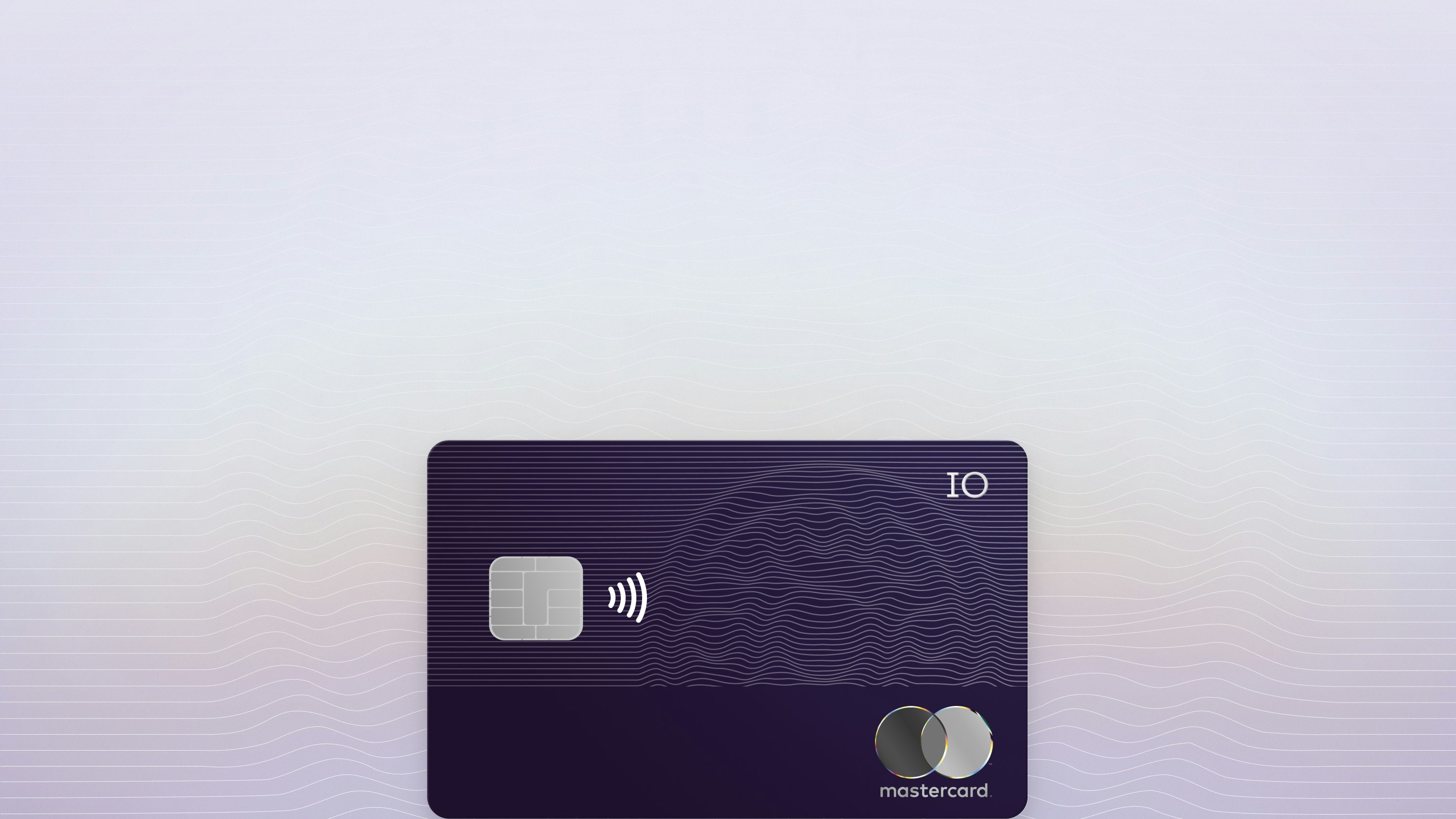 Image of the IO card at an angle with line drawing of IO logo in the background