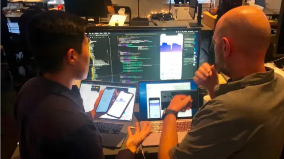 Merucury employees Michael and Sebastien developing the iOS app.