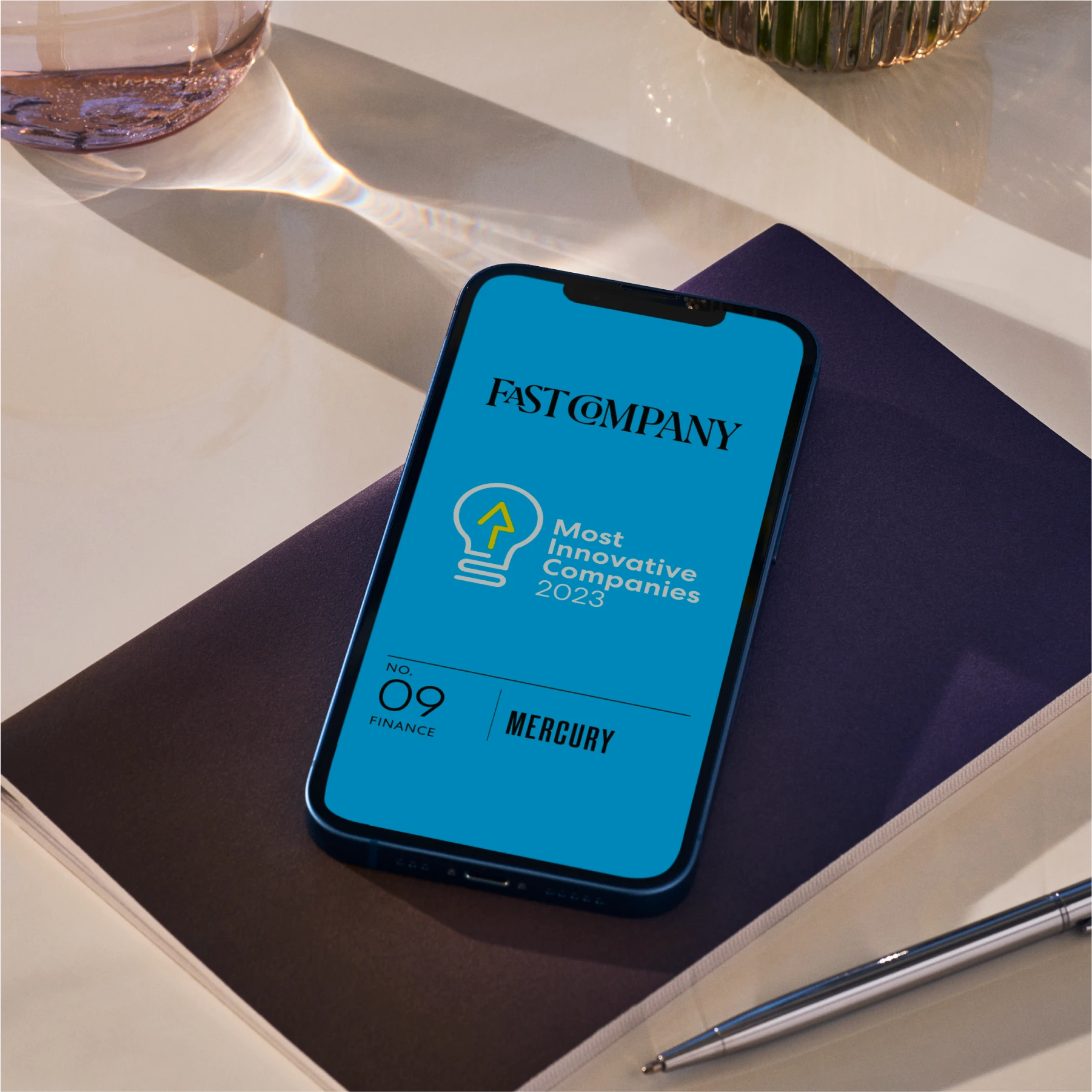 Mockup of a phone with the Fast Company logo and Mercury as No. 9 in their list of Most Innovative Companies 2023