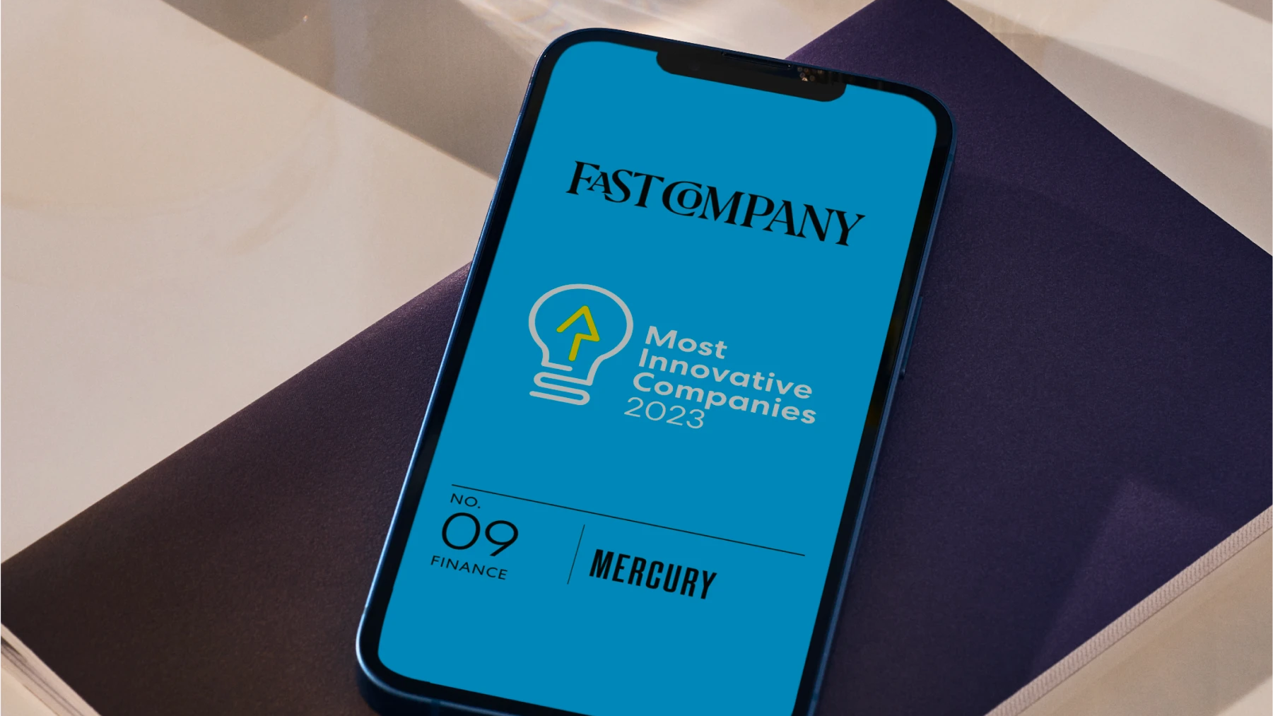 Mockup of a phone with the Fast Company logo and Mercury as No. 9 in their list of Most Innovative Companies 2023
