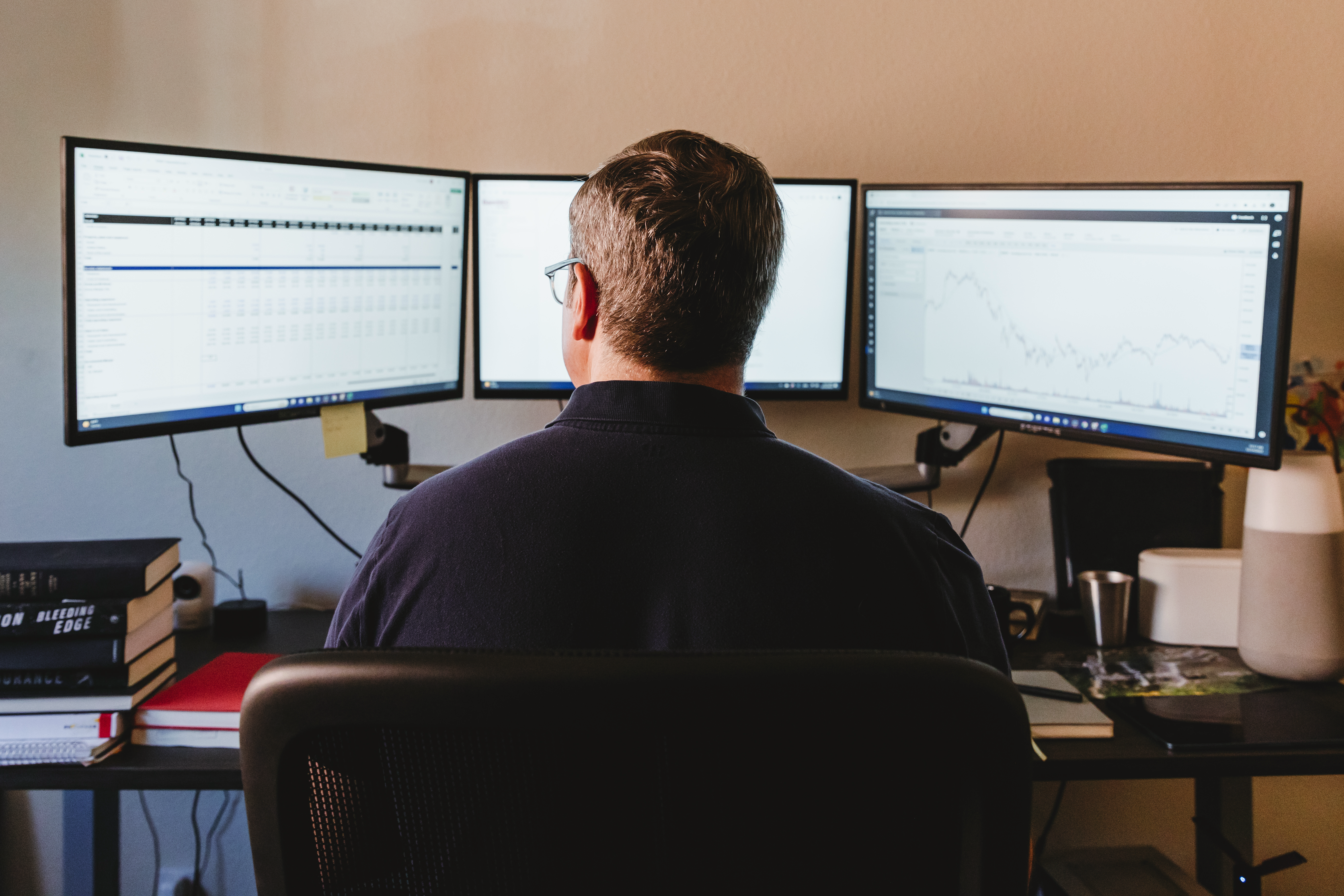 Hobart at his desk, with a three monitor setup.