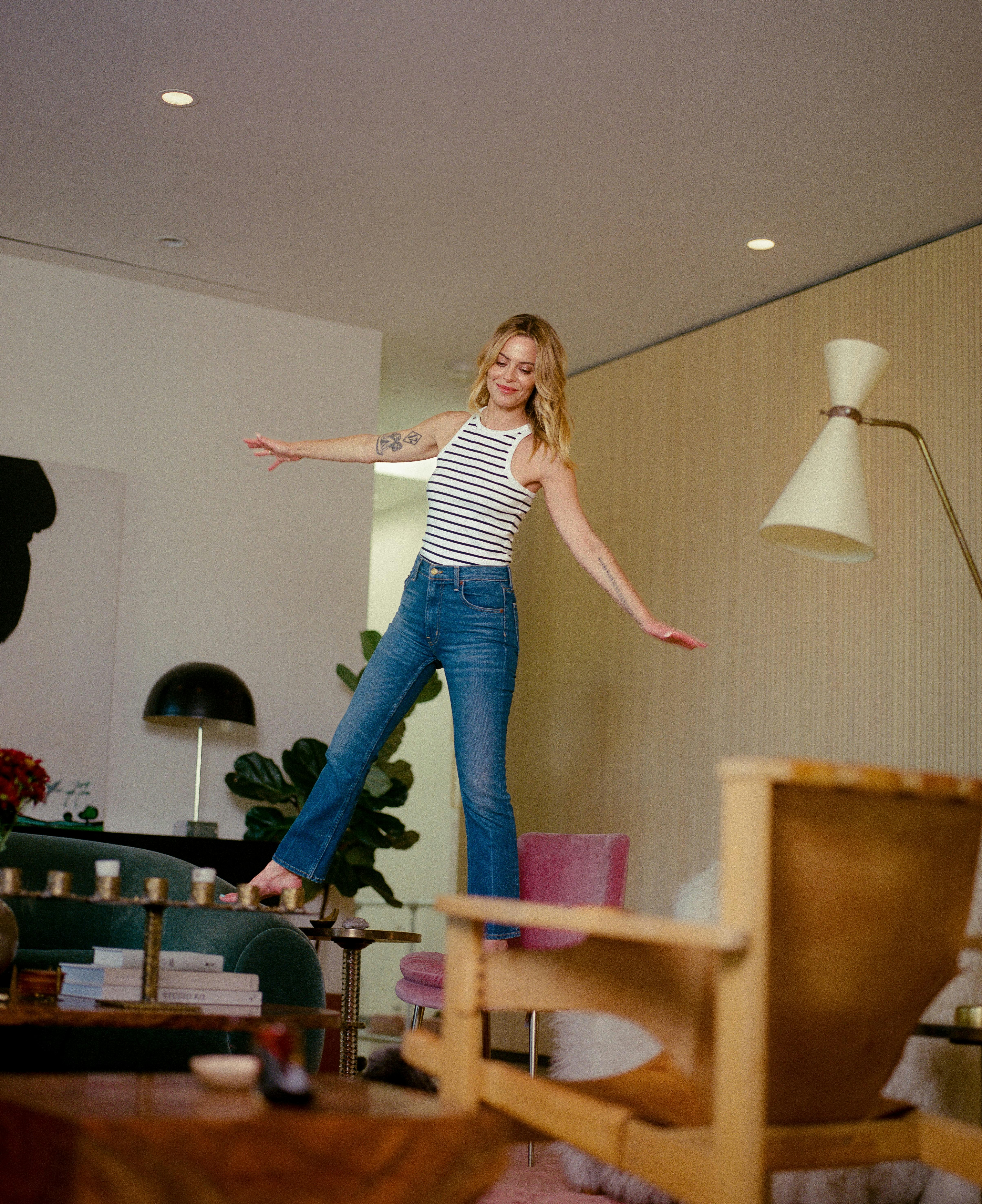 Image of Sophia Amoruso playfully standing on table and couch in her home, balancing | Profile: Sophia Amoruso doesn't need a clean slate | Meridian by Mercury Image of Sophia Amoruso playfully standing on table and couch in her home, balancing | Profile: Sophia Amoruso doesn't need a clean slate | Meridian by Mercury