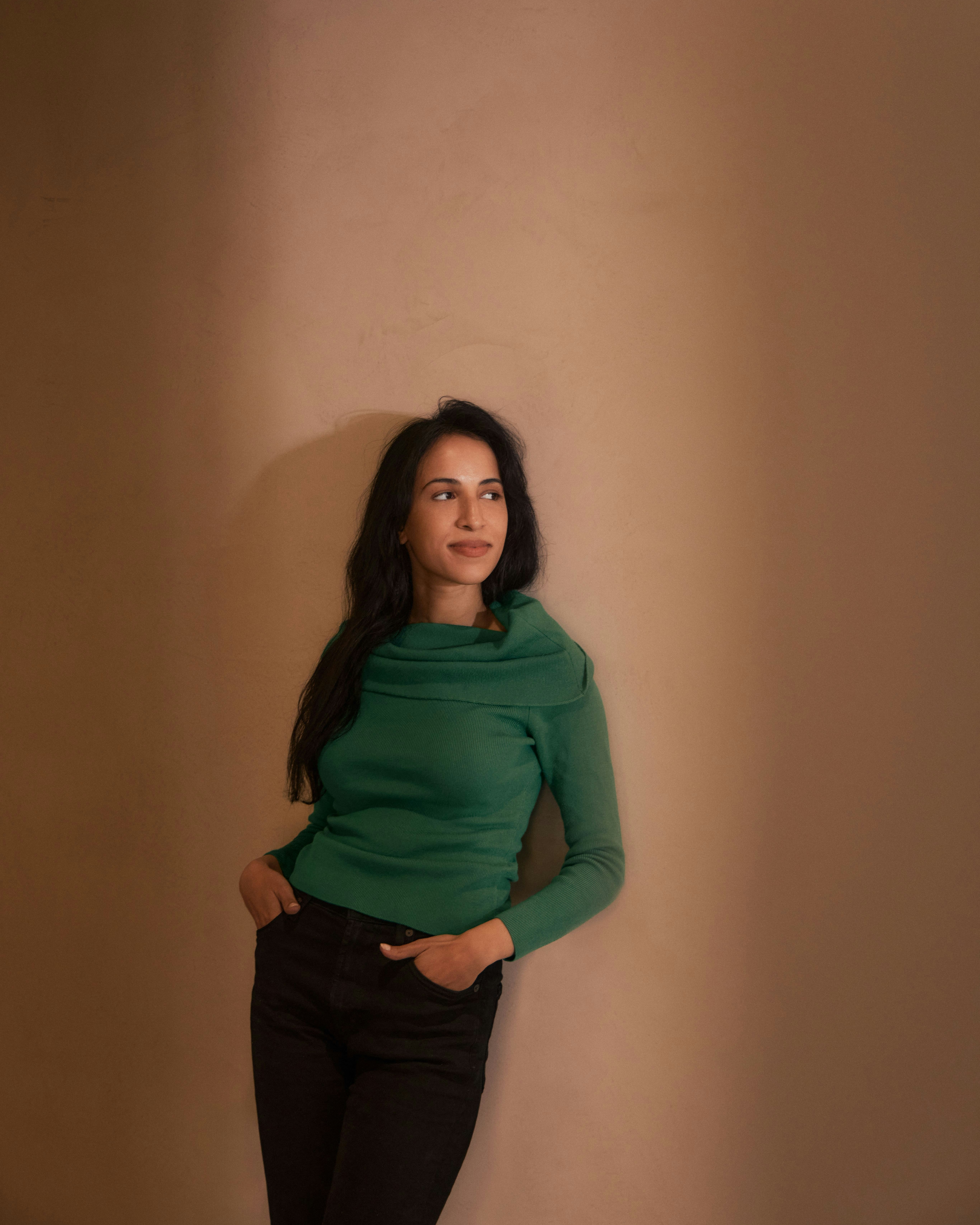Photography by Derek Yarra of Noor Siddiqui standing against a wall | Meridian by Mercury Photography by Derek Yarra of Noor Siddiqui standing against a wall | Meridian by Mercury