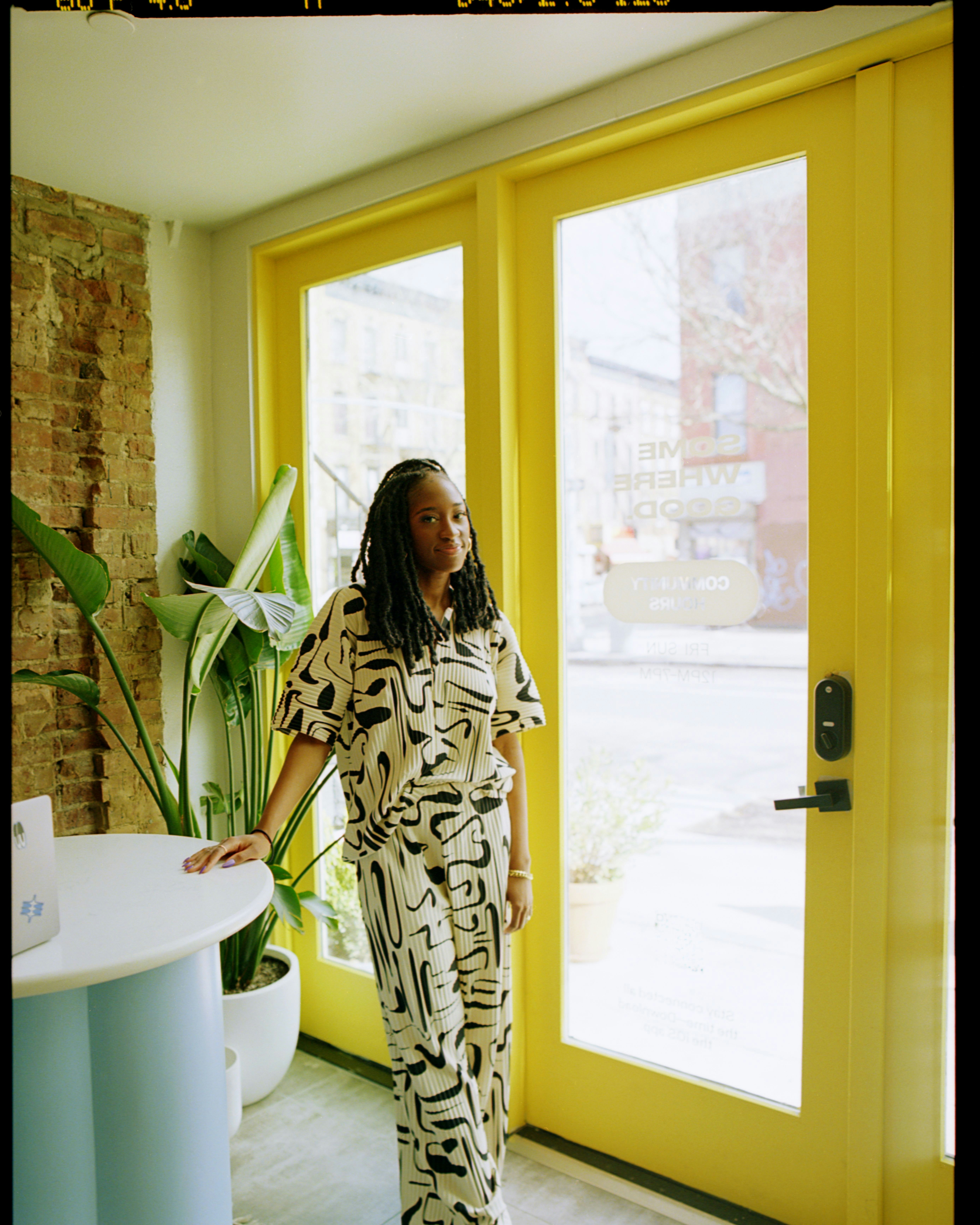 Naj Austin pivots with a mission Photo of Naj Austin in front of bright yellow doors | Meridian by Mercury