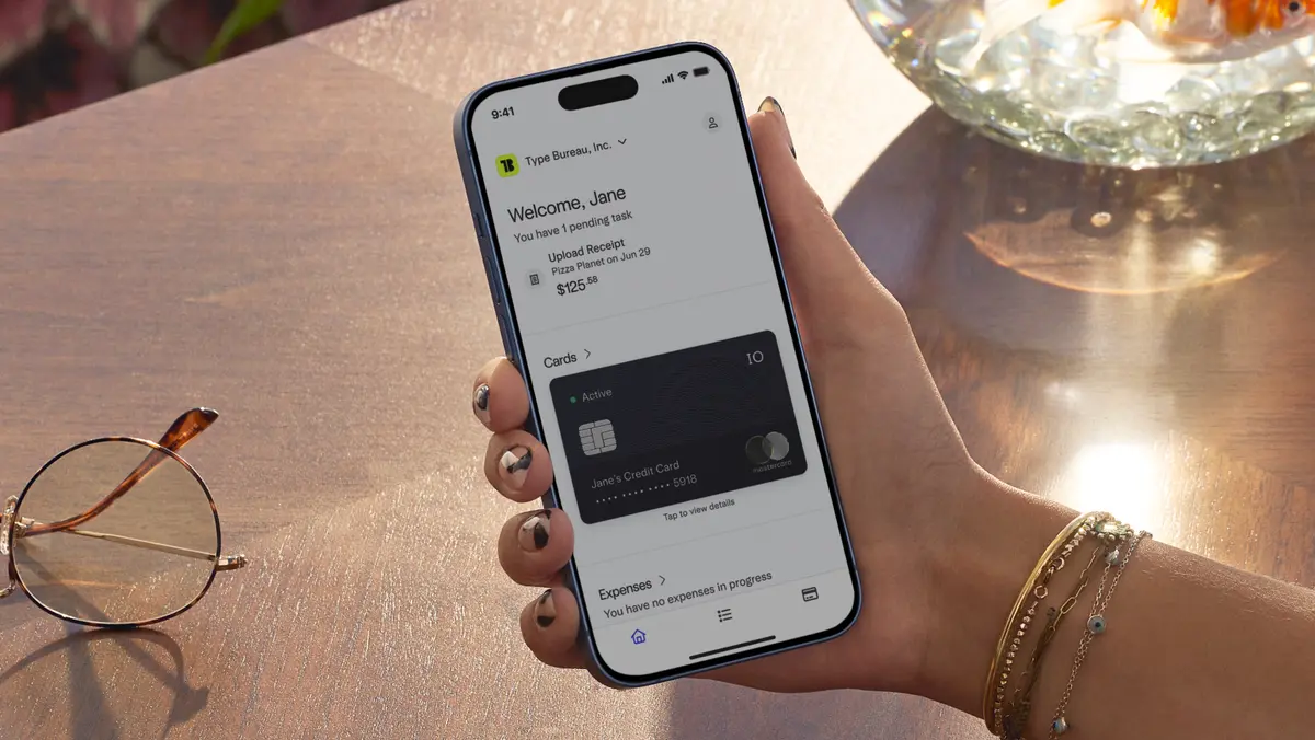 Image of employee holding phone with the Mercury mobile app