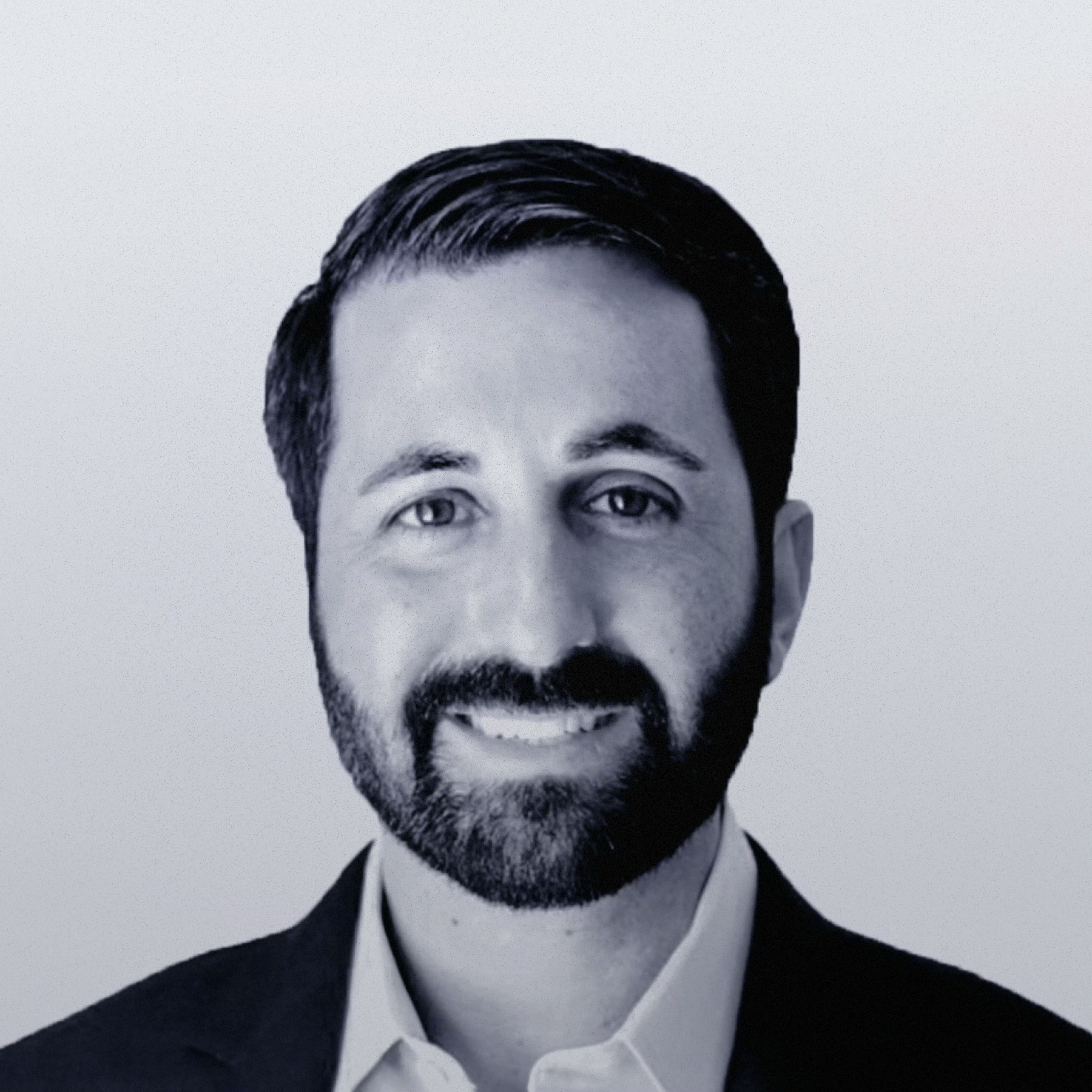 Headshot of Sasha Orloff, Founder and CEO of Puzzle wearing a suit.