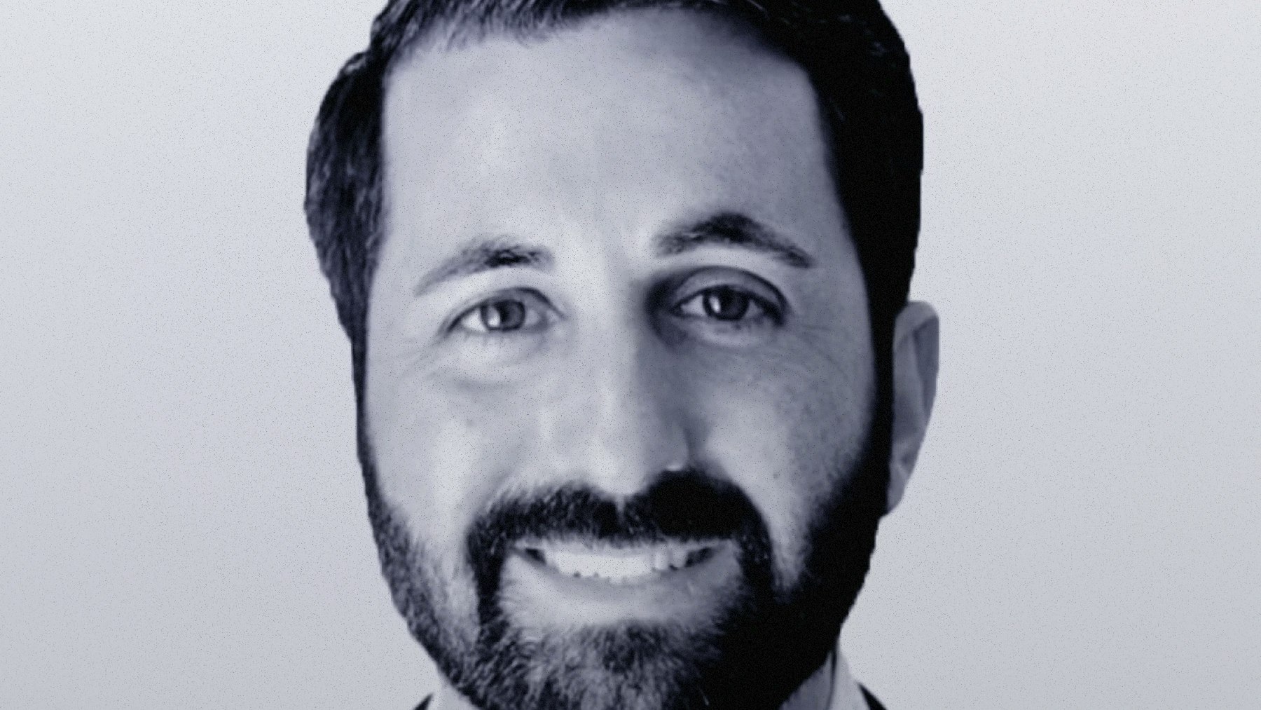 Headshot of Sasha Orloff, Founder and CEO of Puzzle wearing a suit.