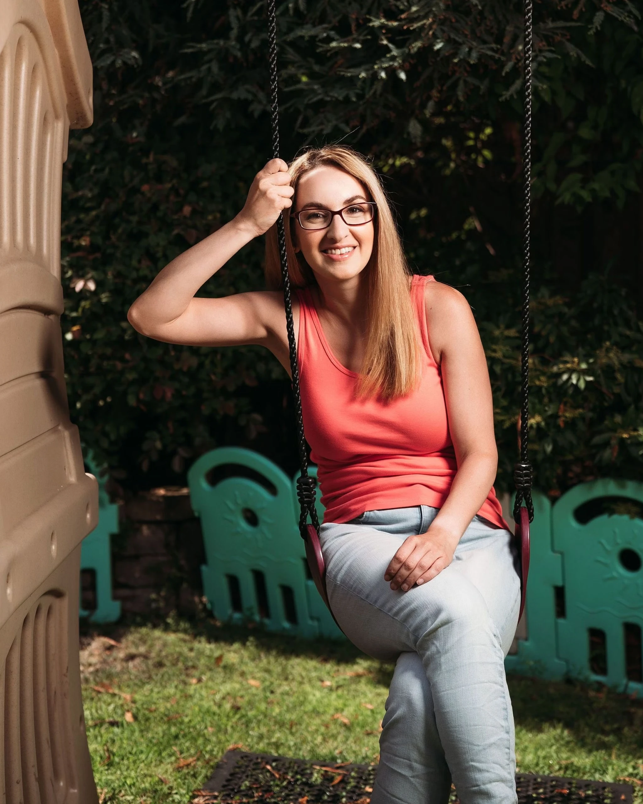Portrait of Sara Mauskopf on a children's swingset