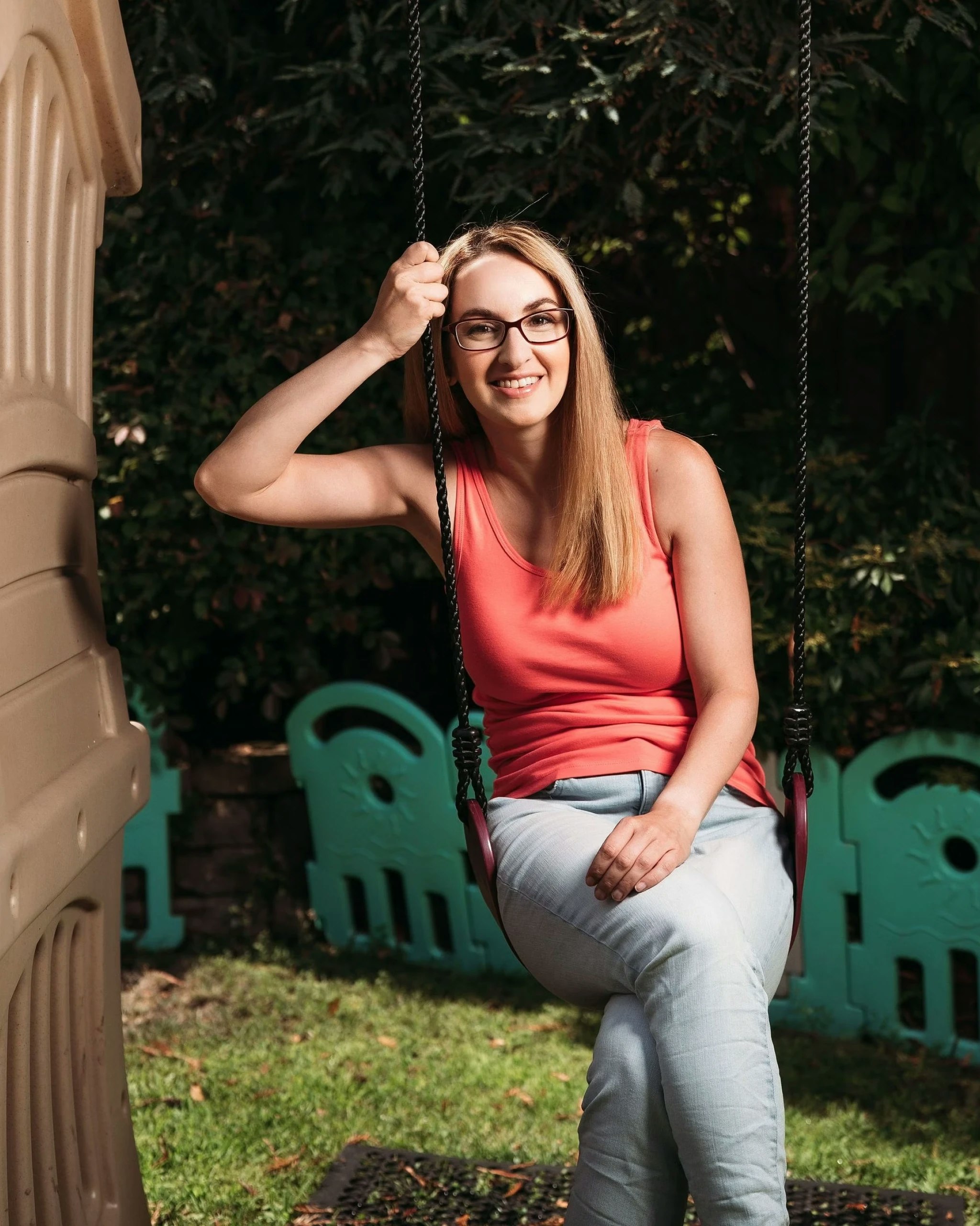 Portrait of Sara Mauskopf on a children's swingset