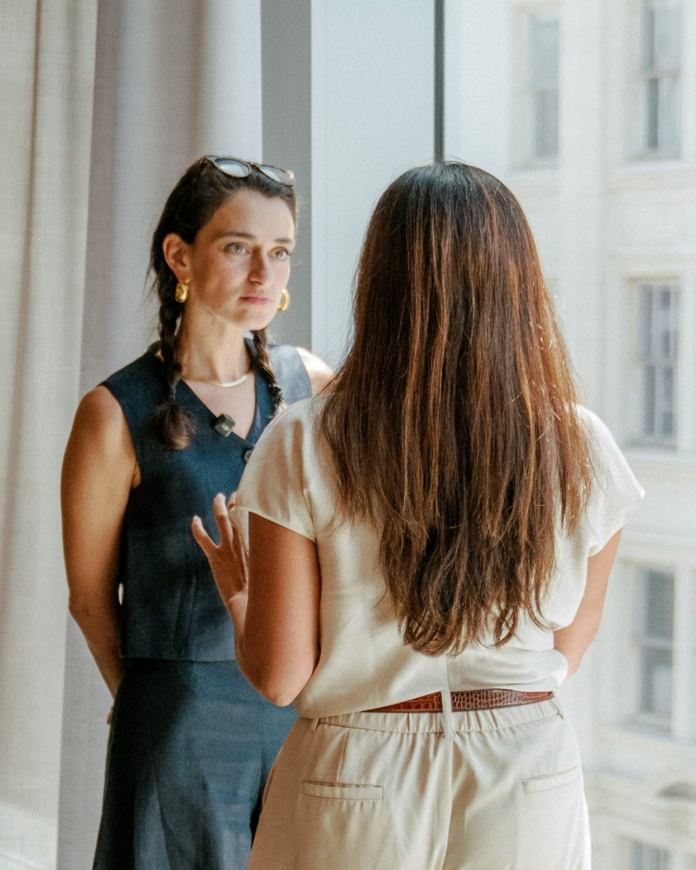 Two women in conversation, one is Rebecca Millstein.