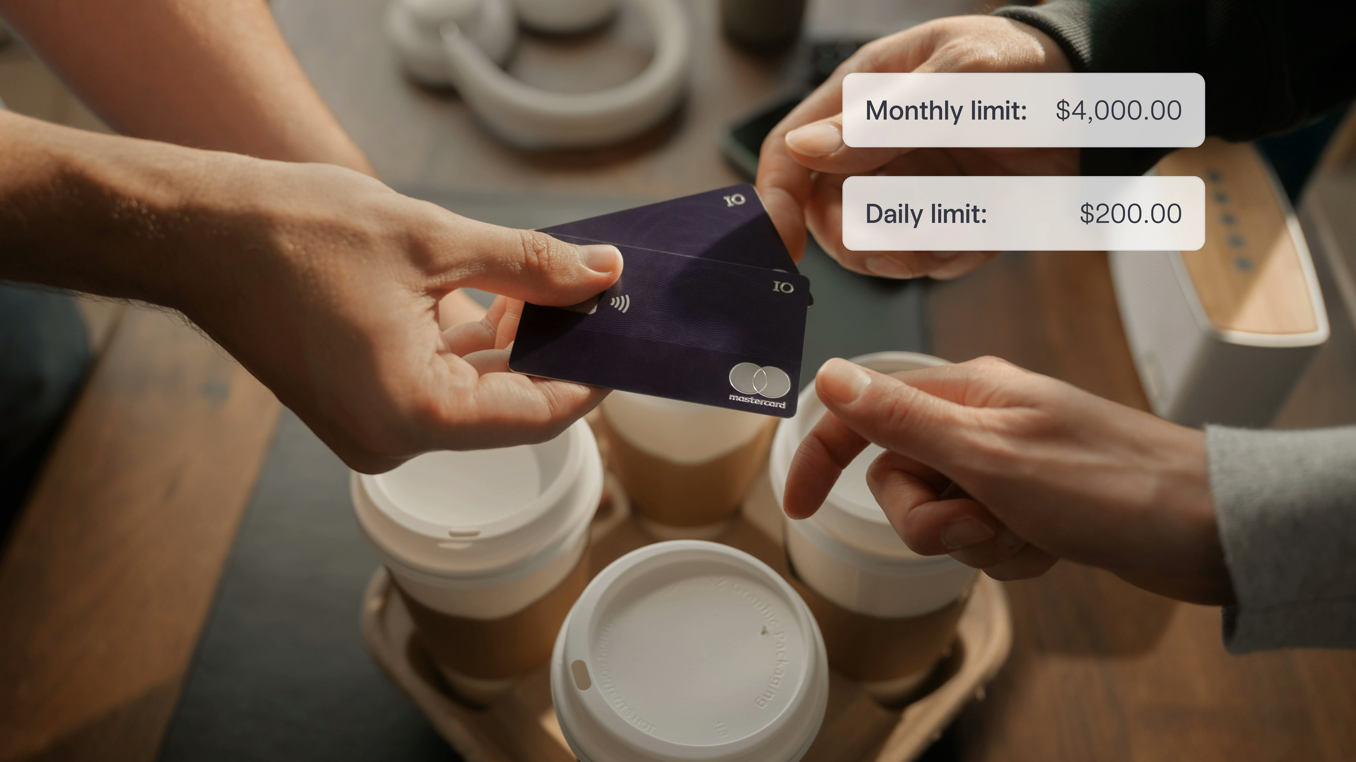 Photo of IO credit card being exchanged among hands