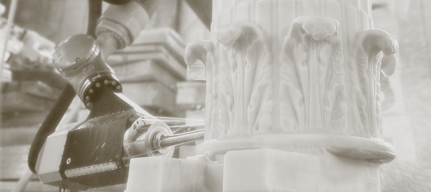 Photo from Monumental Labs of column being chiseled
