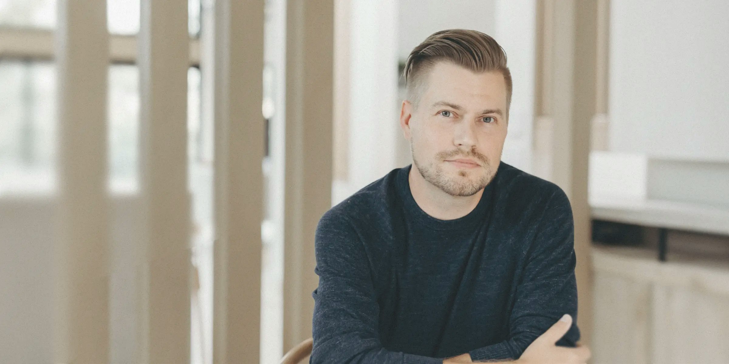Portrait of a man sitting indoors next to a testimonial about Mercury’s speed and ease of use.