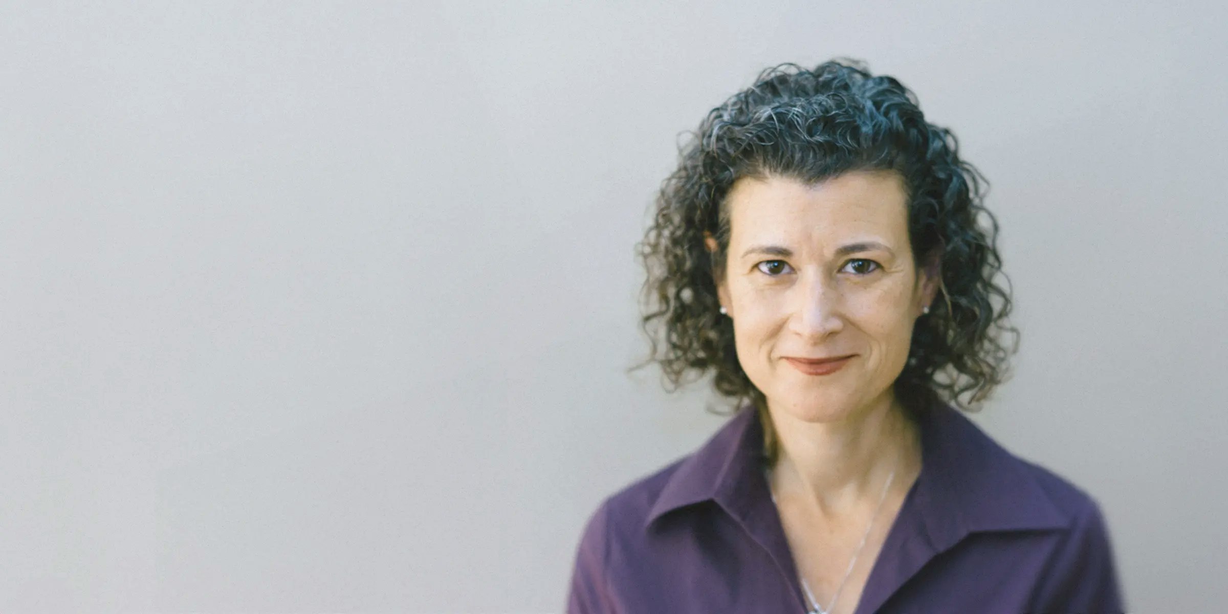 Portrait of a woman indoors next to a testimonial about Mercury’s built-in permissions.