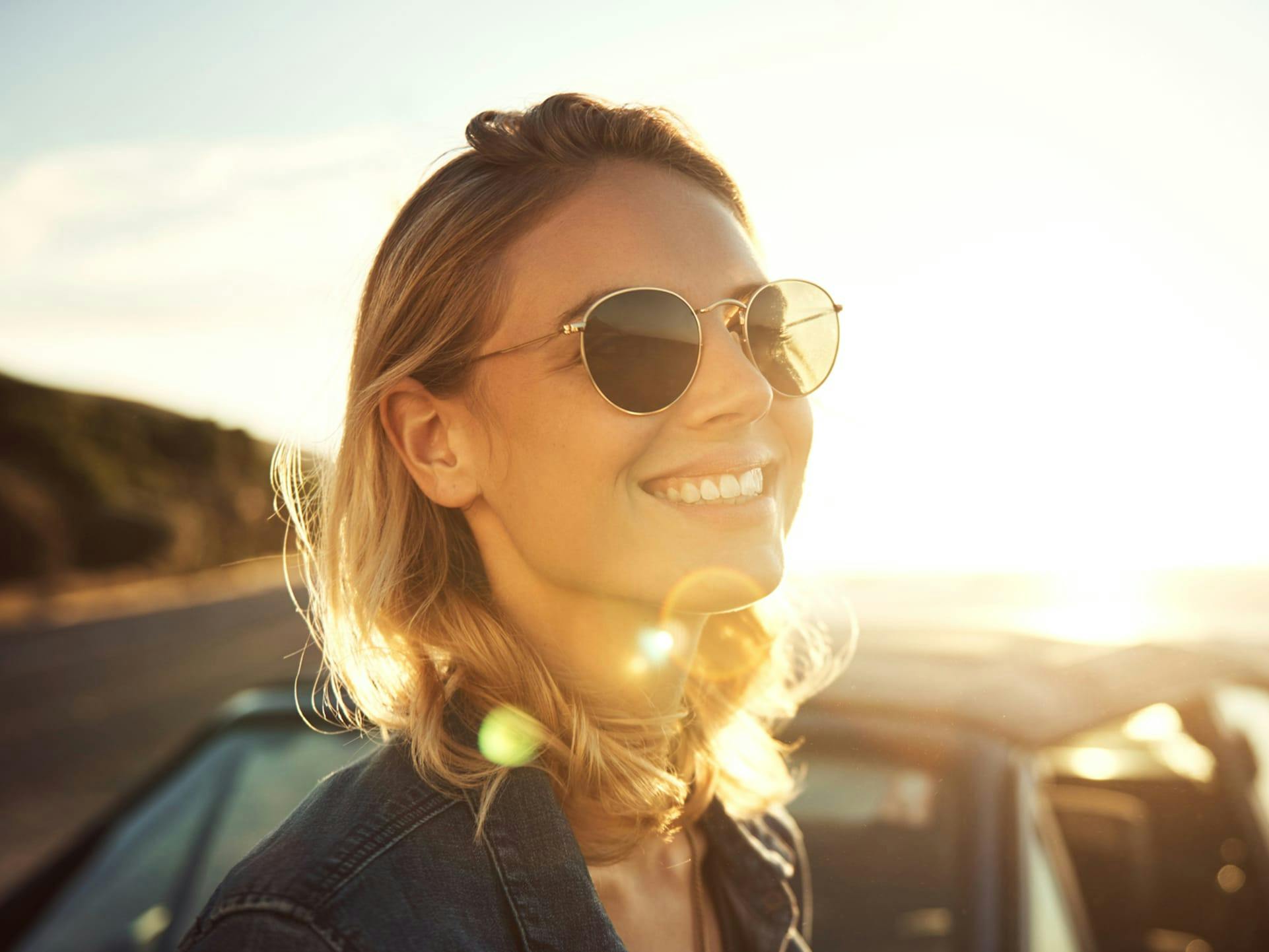 standing next to car at beach