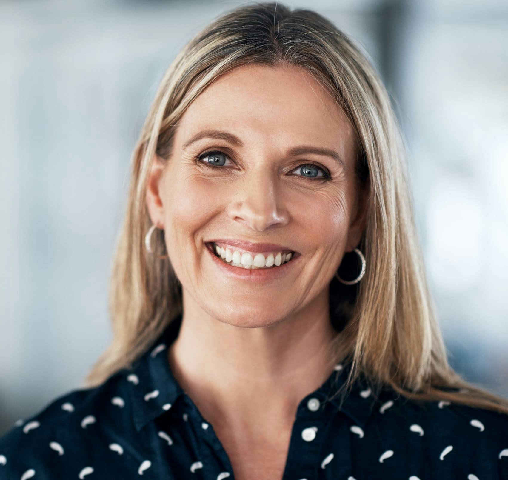 smiling in polka dot blouse