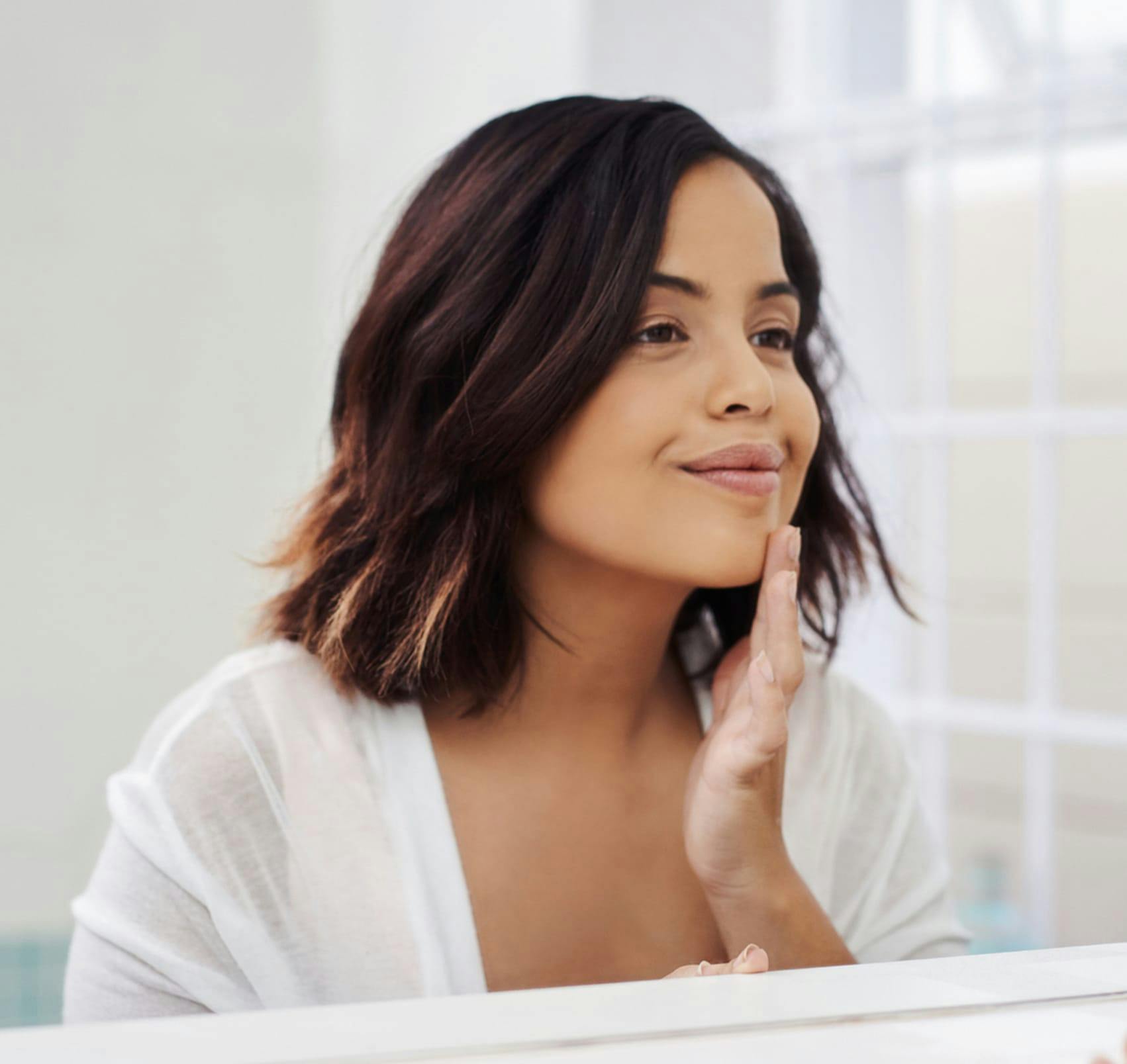 checking chin in mirror