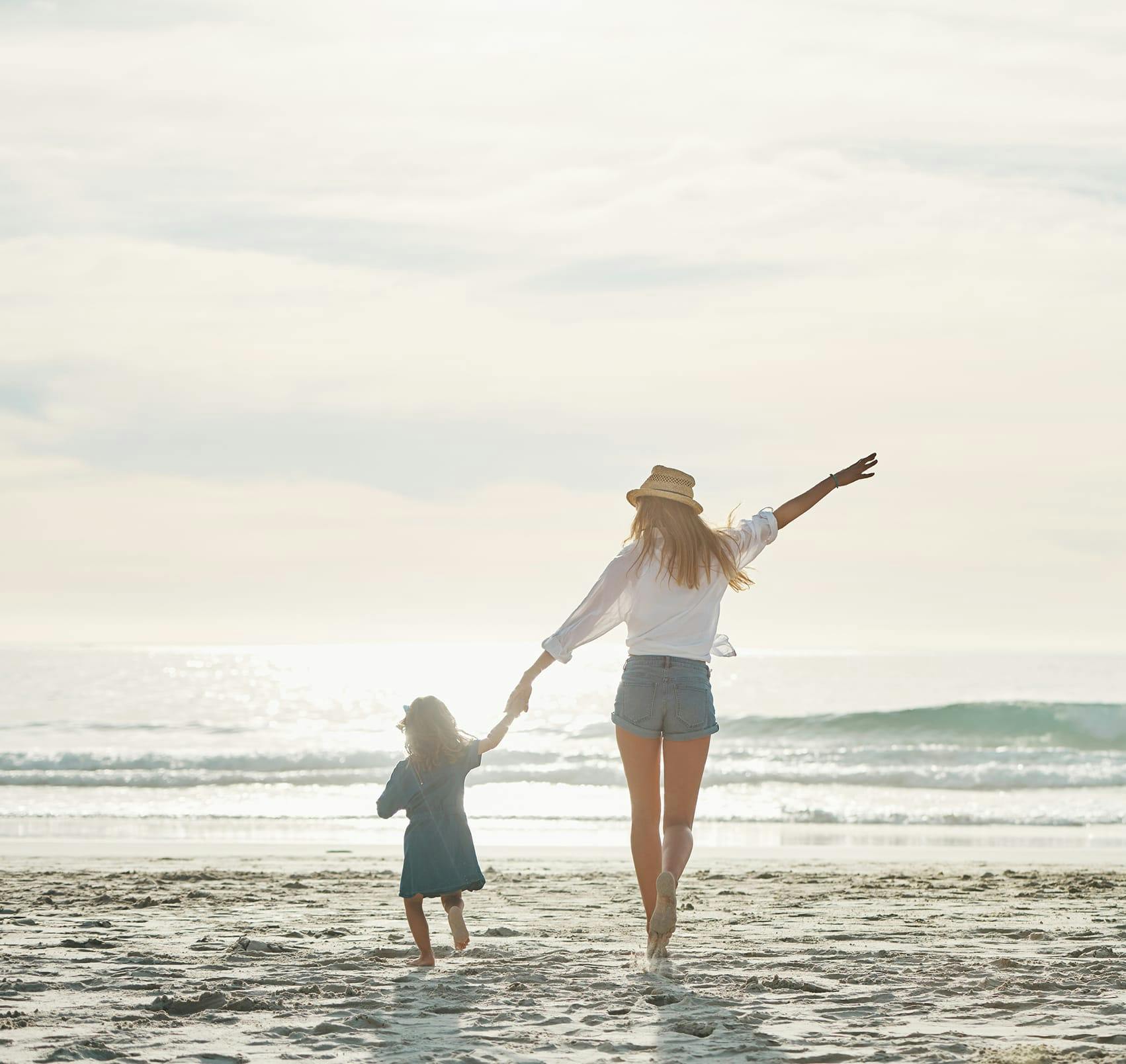 walking on beach with child