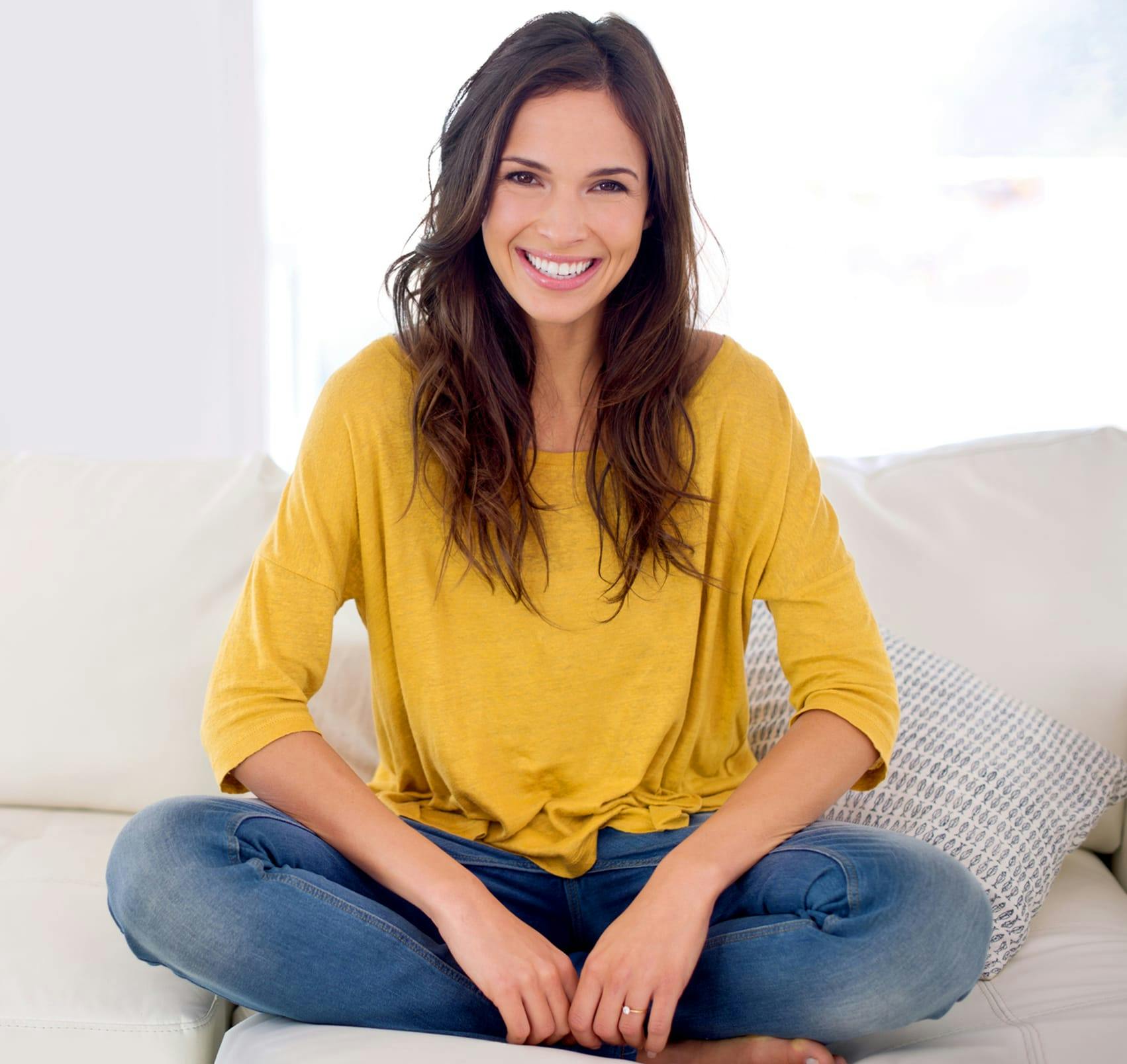 sitting cross-legged on couch