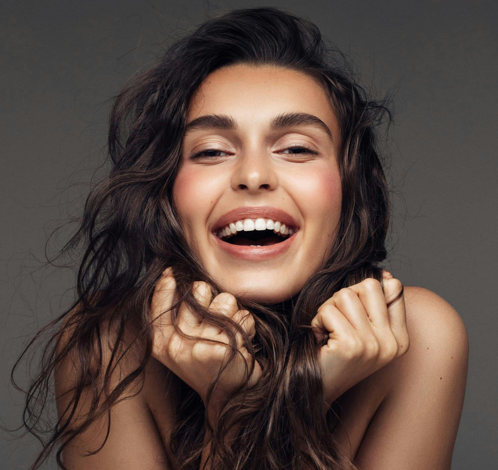 smiling holding hair