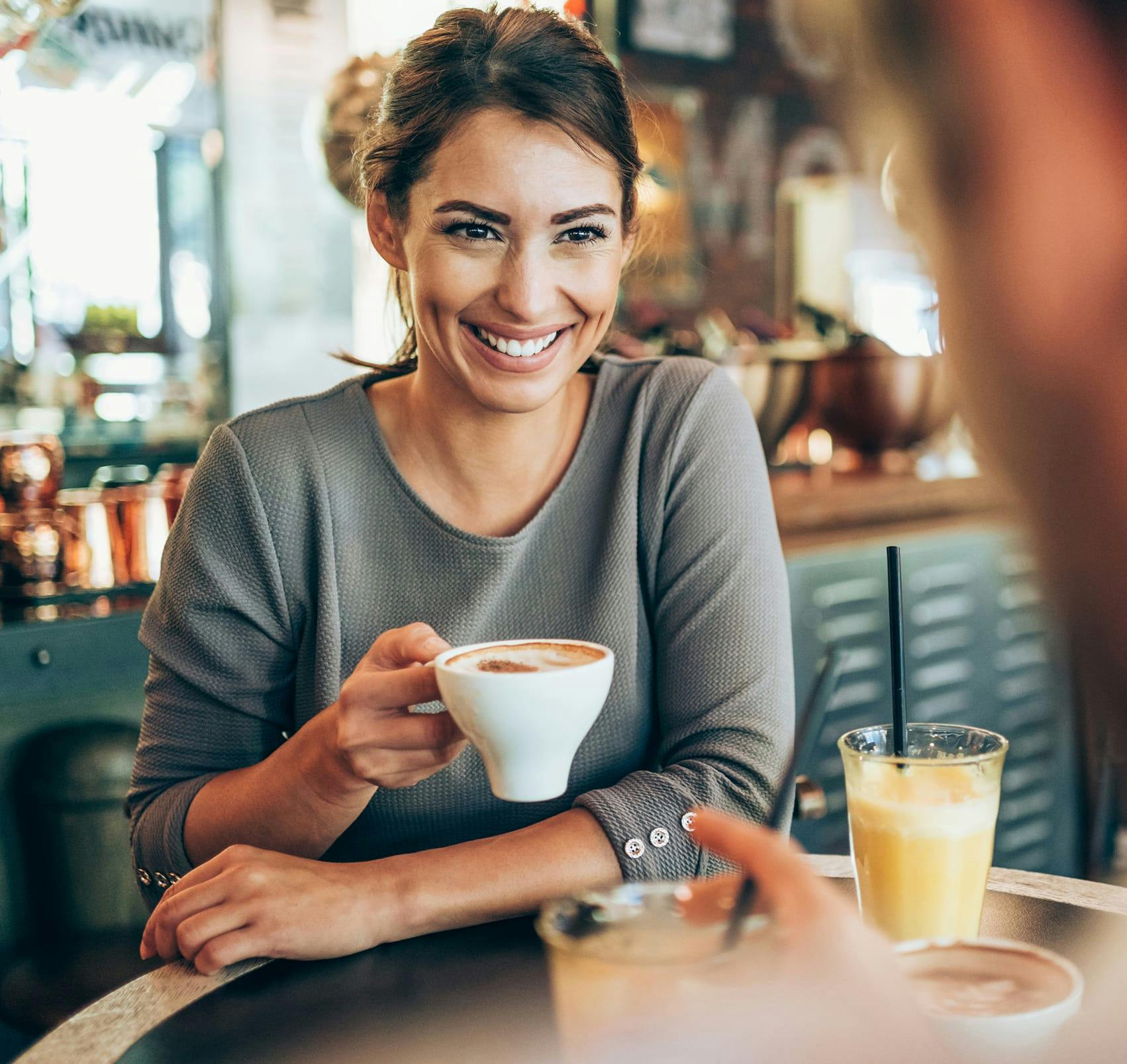 woman drinking espresso with a man