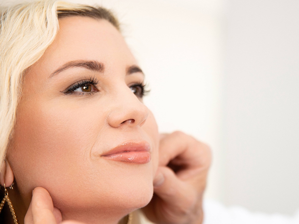 blonde woman getting skin consultation