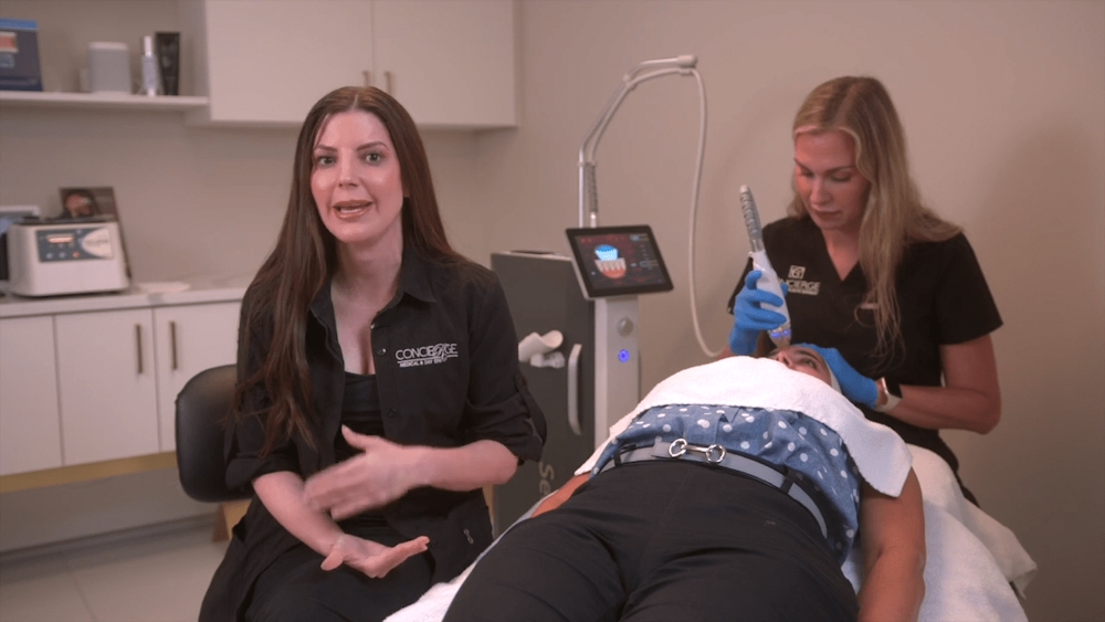 Staff at Concierge explaining what radiofrequency microneedling is
