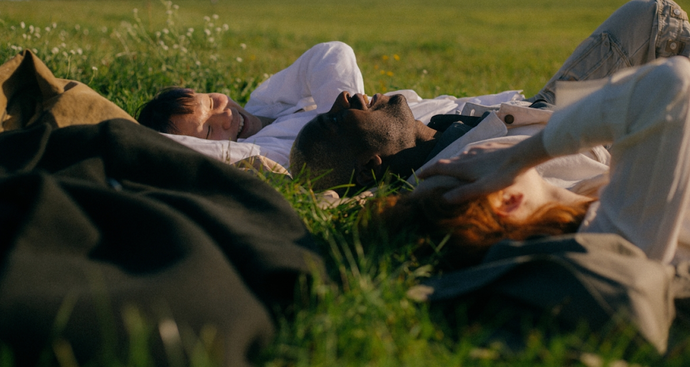 People lying on grass looking up at sky