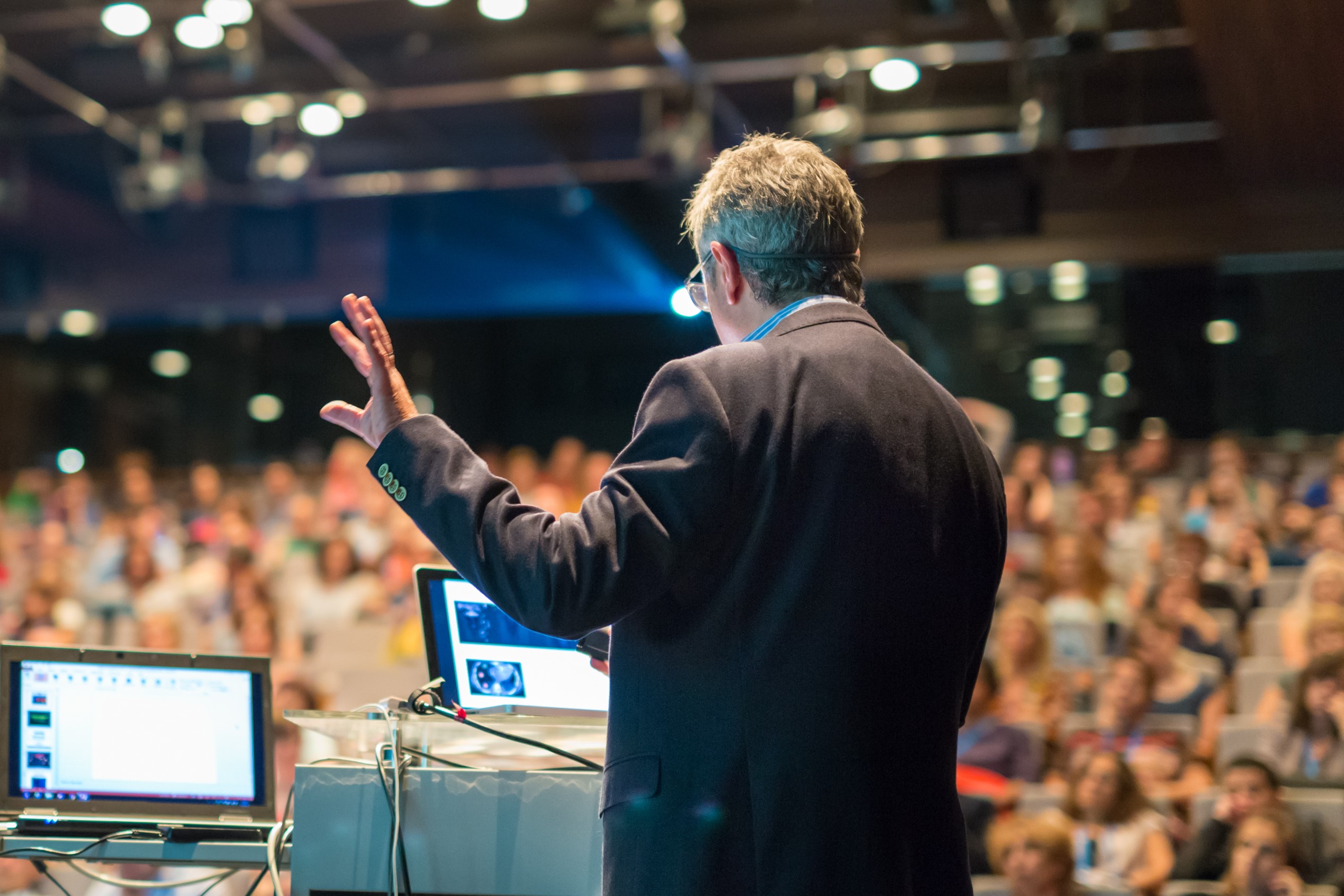 The man is speaking to an audience.